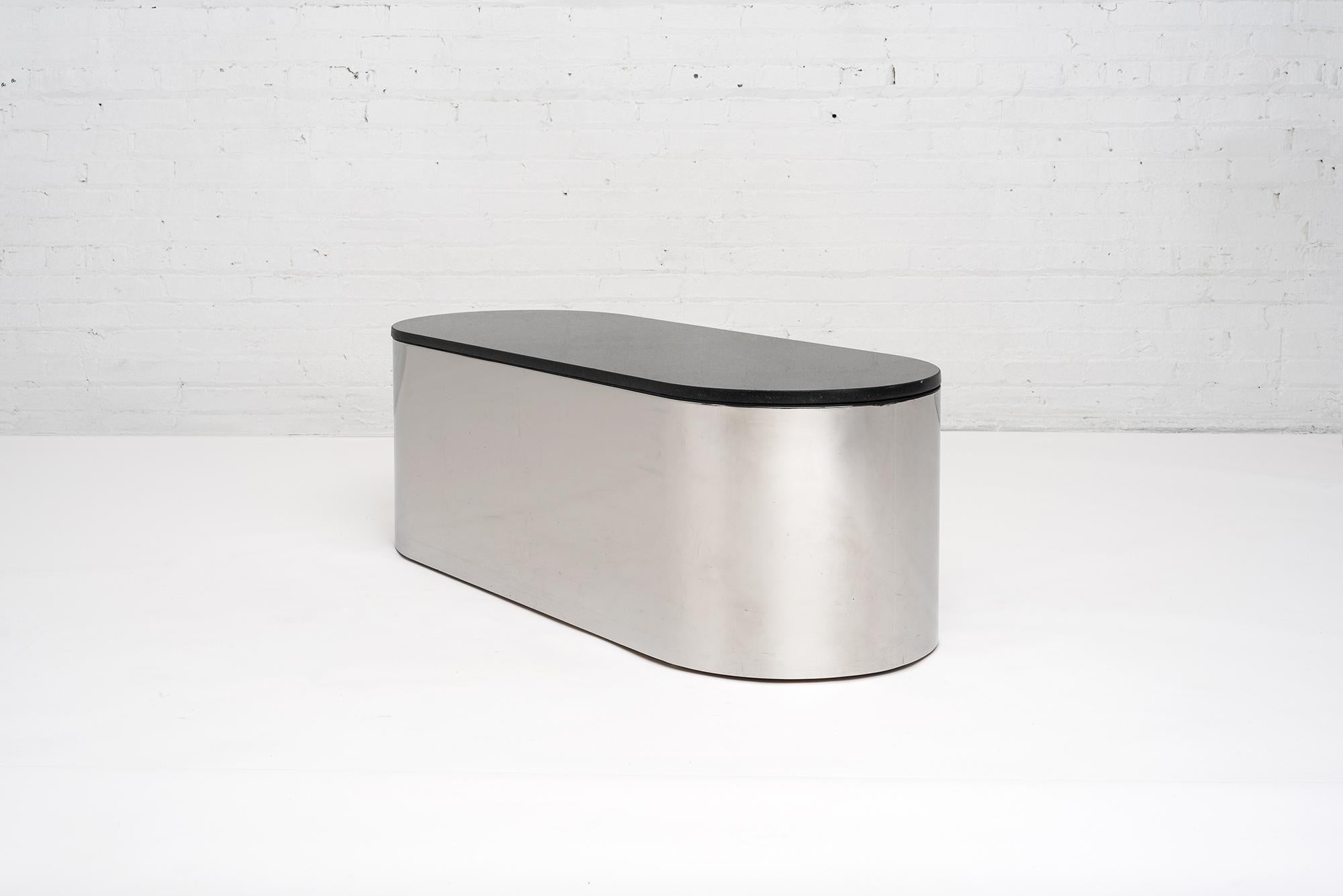 Brueton stainless steel and black granite coffee table, circa 1970s. Heavy stainless steel construction which Brueton is known for with 3/4” thick black granite. Polished chrome finish.