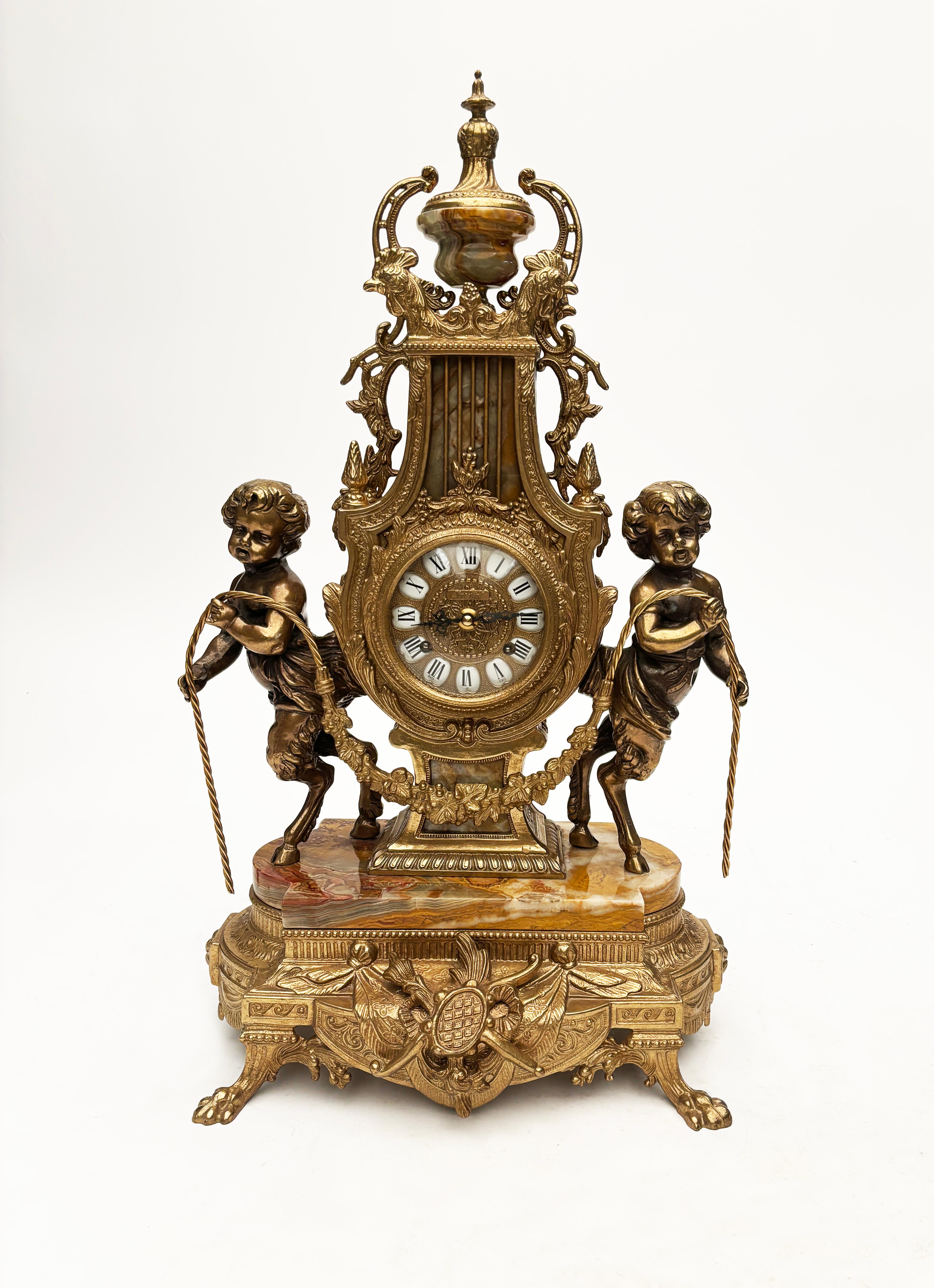 This stunning brass and marble Italian clock and candelabras is visually tantalizing with specular detail that Brevettato is especially known for in their creations.  The stone found within each piece of this trio is beautiful Italian marble having
