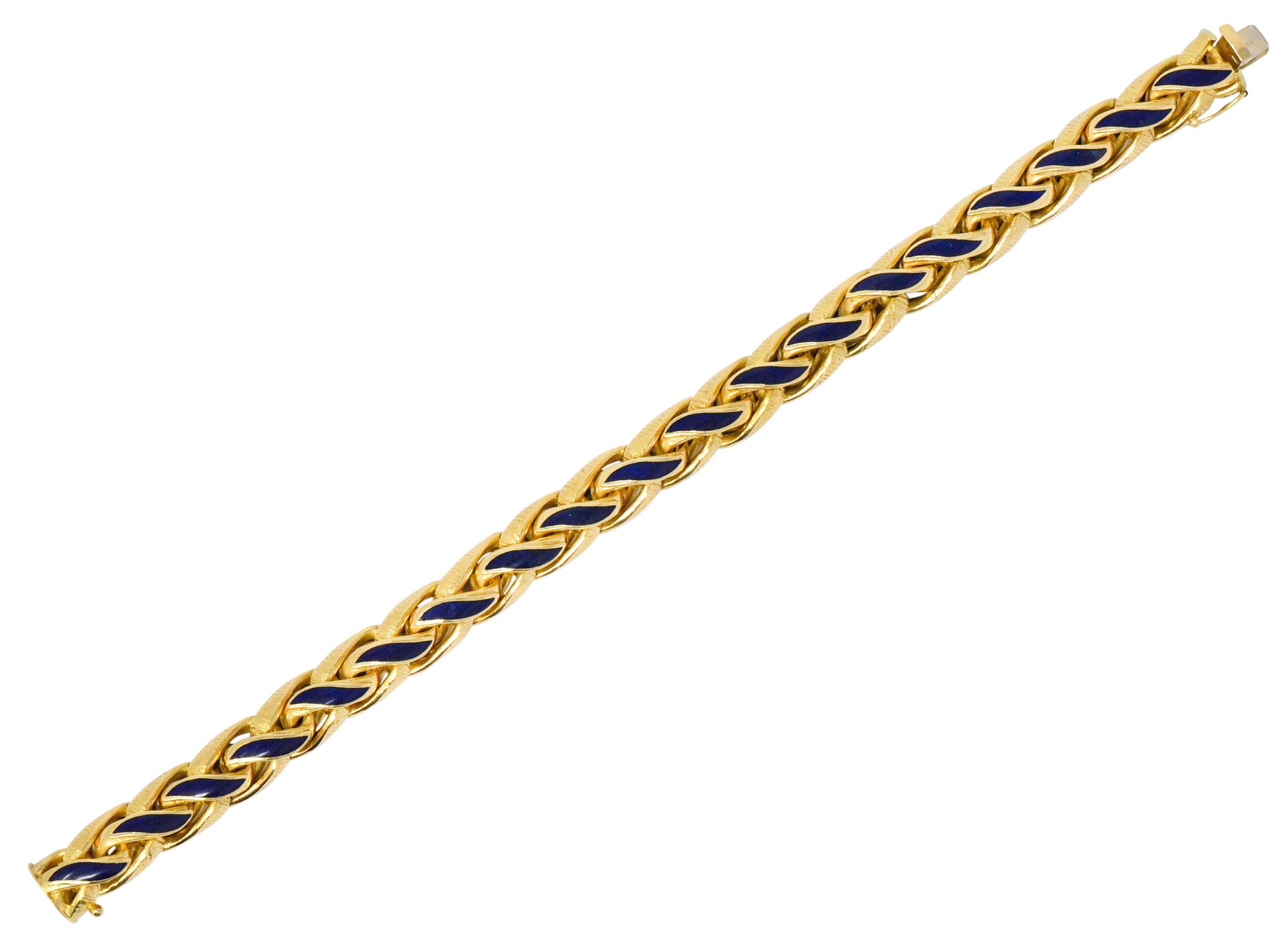 Braided wheat style bracelet centering ultramarine blue enamel detail

Accented by deeply engraved texture on profile facing links

Completed by concealed clasp and figure-eight safety

Maker's mark for Brevetto with partial Italian assay