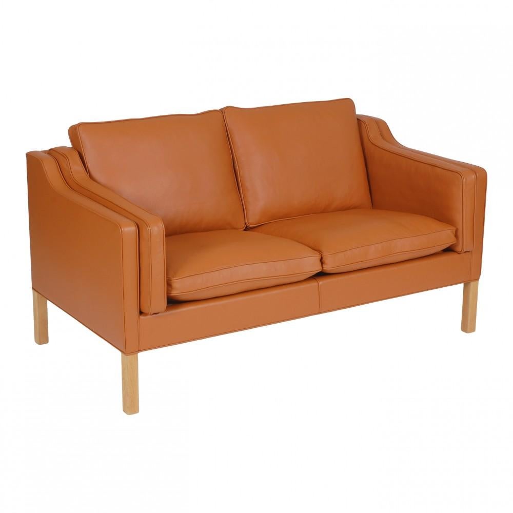 Børge Mogensen 2. Sitzer Sofa neu gepolstert in cognac Bizon Leder und mit neuen Kissen montiert. Das Sofa ist ein Original von Fredericia Furniture, das nach den ursprünglichen Methoden neu gepolstert worden ist. Beine aus dunklem Teakholz.