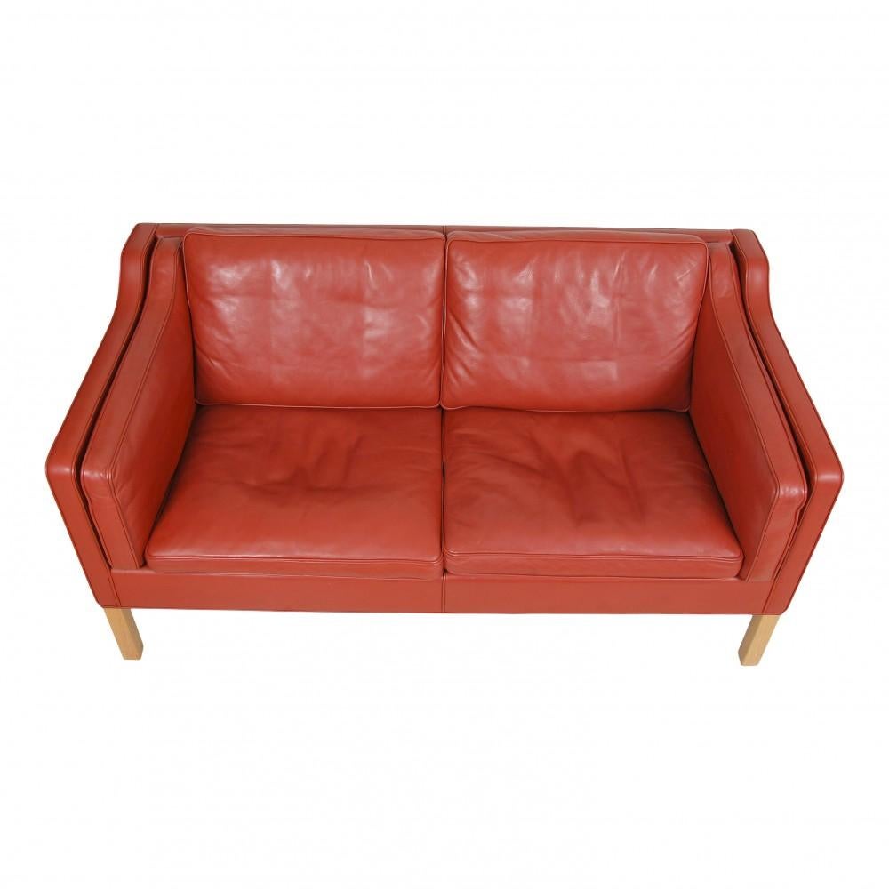 Børge Mogensen 2-seater sofa, model 2212, in original patinated red leather and oak legs. The sofa is from the 80s-90s and appears in good condition with patinated leather.