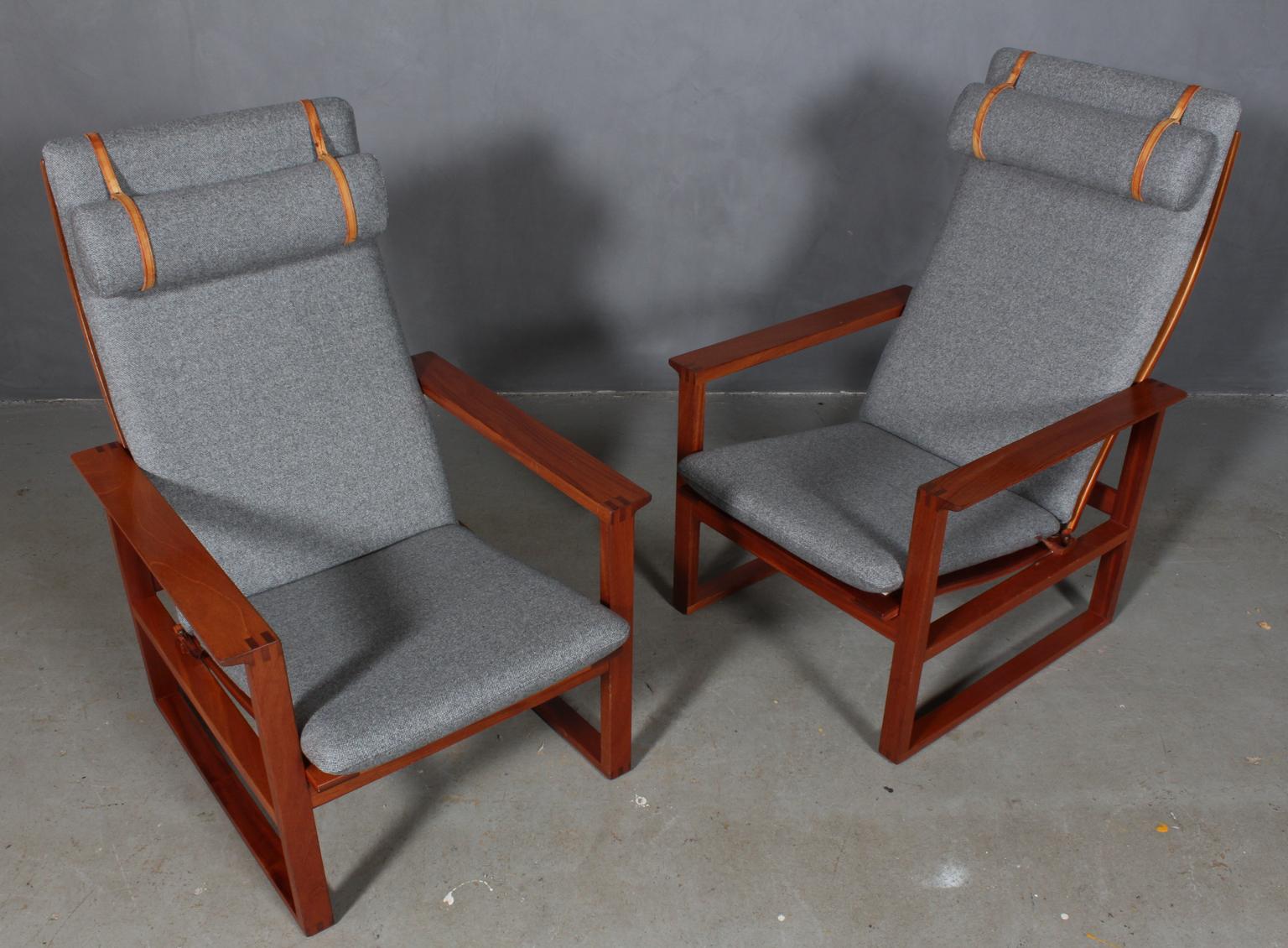 A Børge Mogensen lounge chairs designed in 1956 model number 2254 for Fredericia Stolefabrik. Cubical frames made of solid mahogany with finger joints and cane. 

Reupholstered in grey wool fabric. The seat cushion can be fixed with a leather