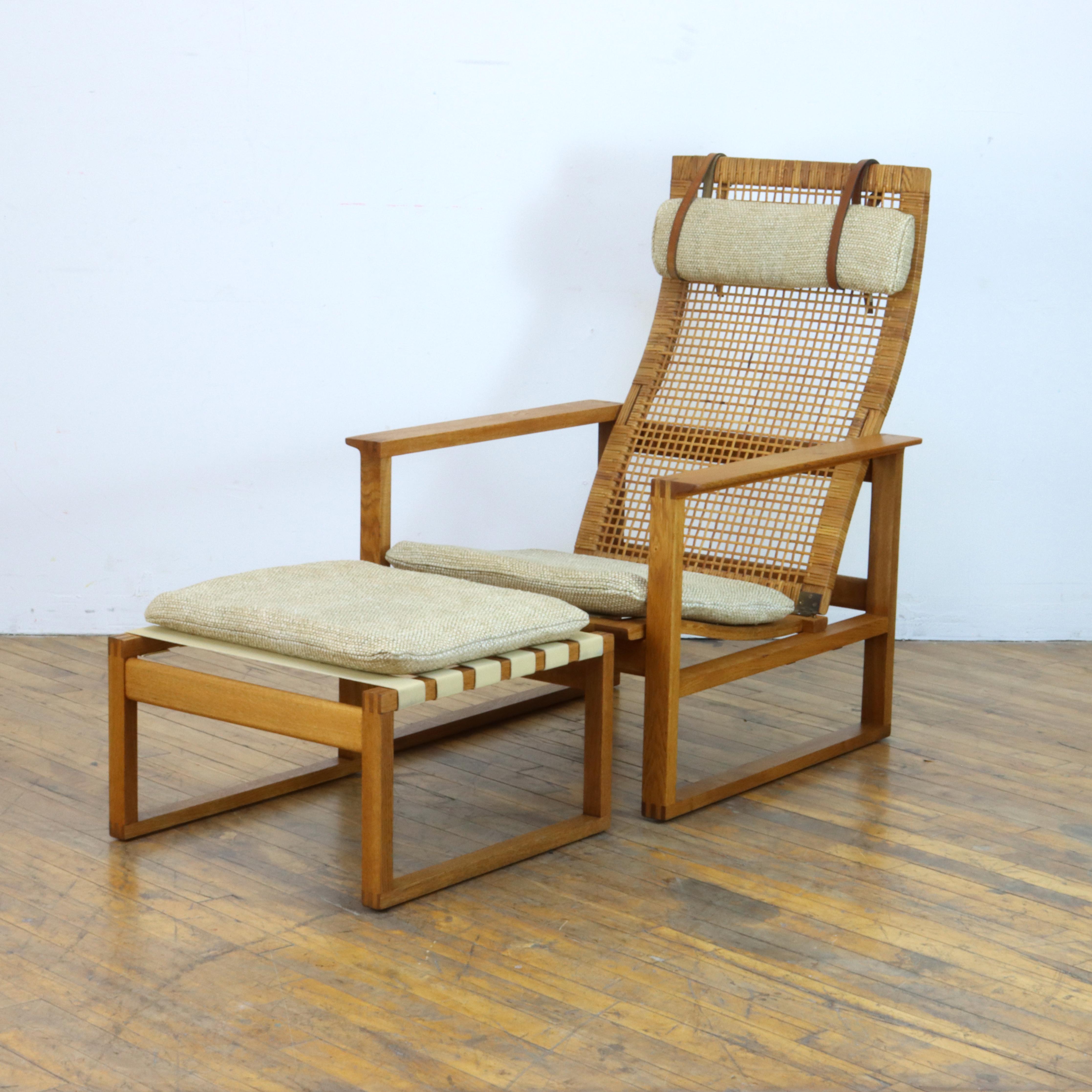 Vintage Børge Mogensen model 2254 reclining lounge chair and ottoman designed in 1954 for Fredericia Stolefabrik; this particular chair features the more unusual (and quite lovely) woven cane back rest. The frame was refinished and new high quality