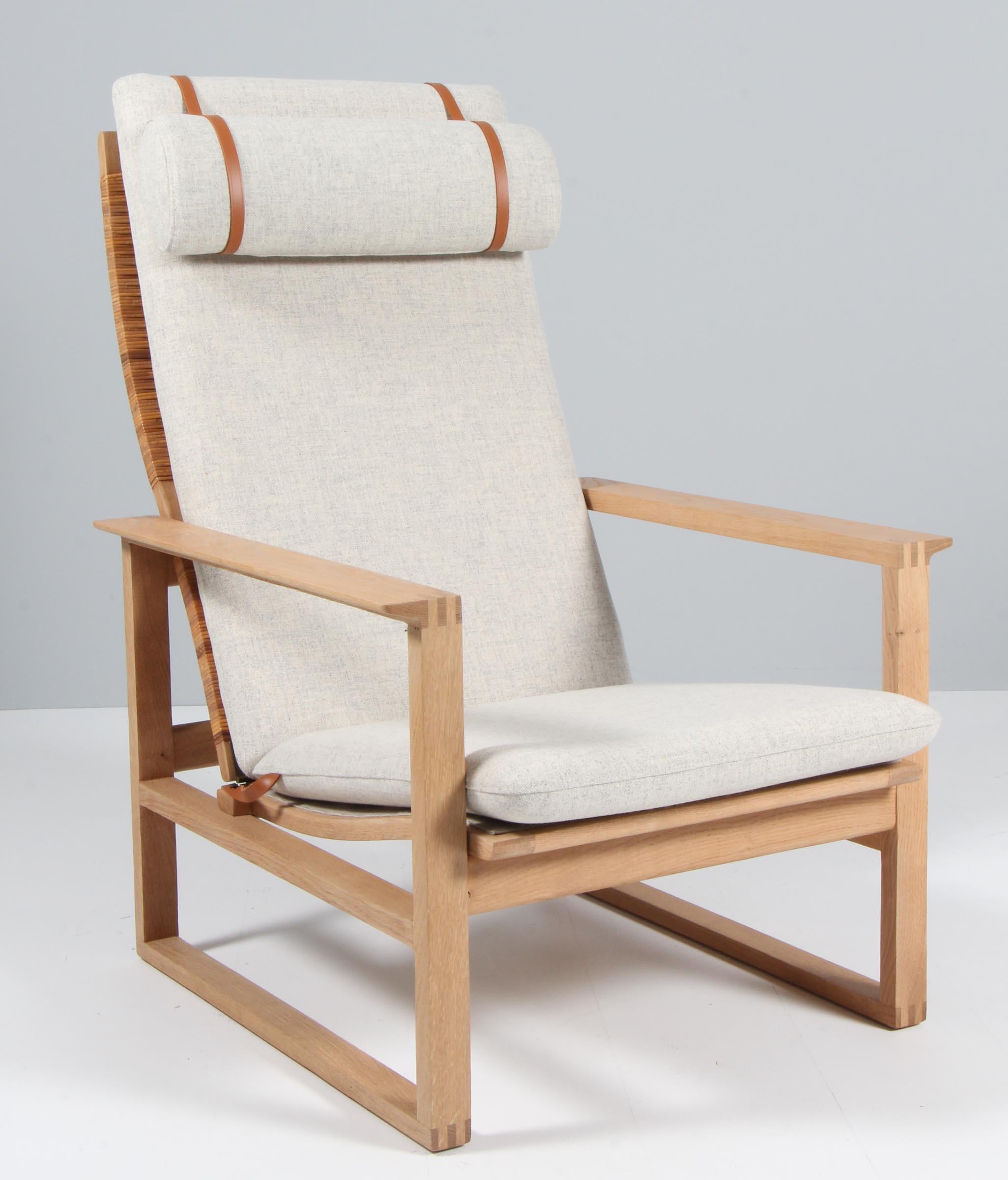 A Børge Mogensen lounge chair designed in 1956 model number 2254 for Fredericia Stolefabrik. Cubical frames made of solid oak with finger joints and cane. This high back model 2254 also reclines.

New upholstered in Kvadrat Tonus 2 11, the chair