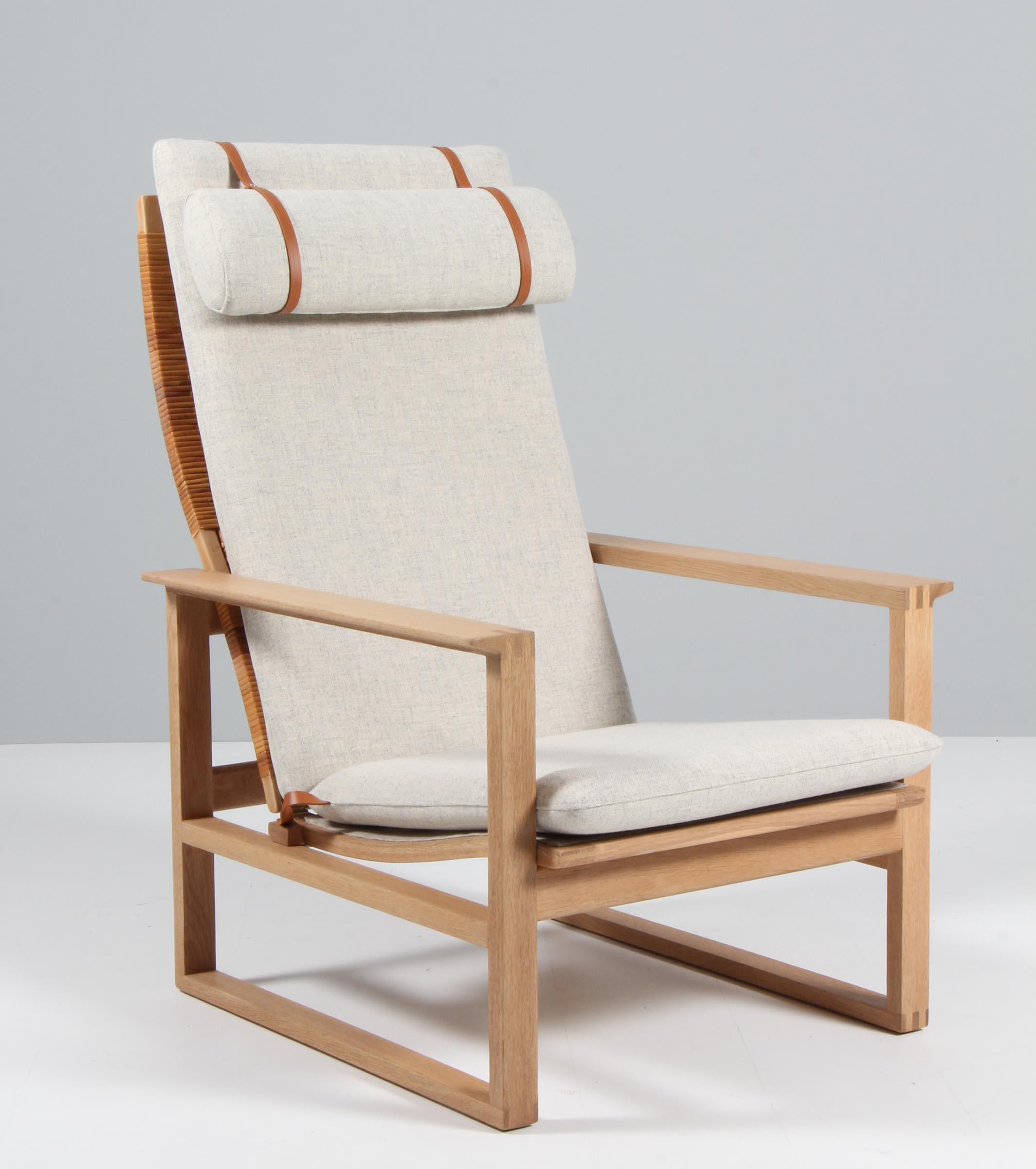 A Børge Mogensen lounge chair designed in 1956 model number 2254 for Fredericia Stolefabrik. Cubical frames made of solid oak with finger joints and cane. This high back model 2254 also reclines.

New upholstered in Kvadrat Tonus 2 11, the chair
