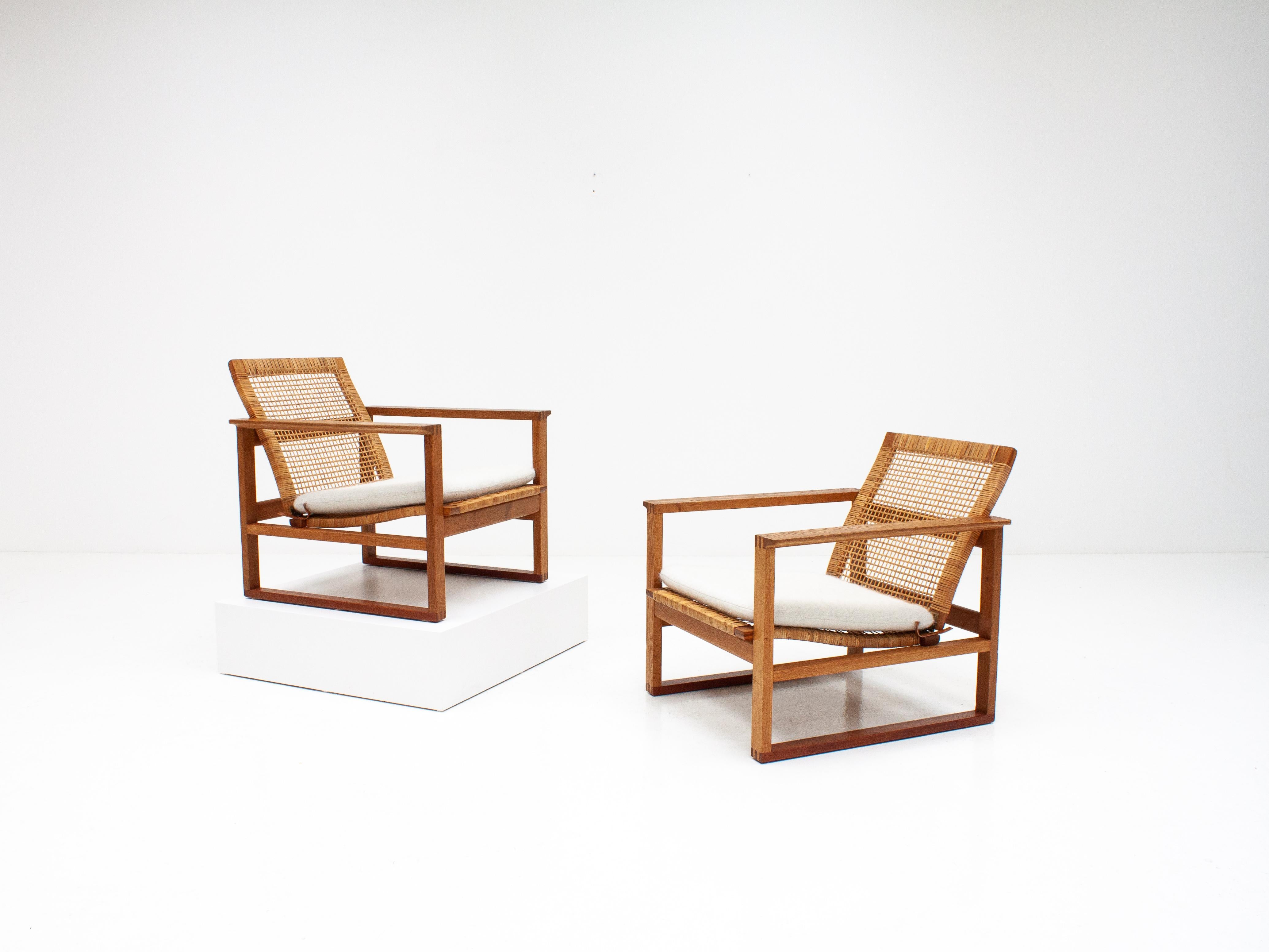 A pair of Børge Mogensen lounge chairs, in cane, designed in 1956, model number 2256 for Fredericia Stolefabrik. Pieces in cane are rare and are early production.

Consisting of cubical frames made of solid oak with finger joints. Newly