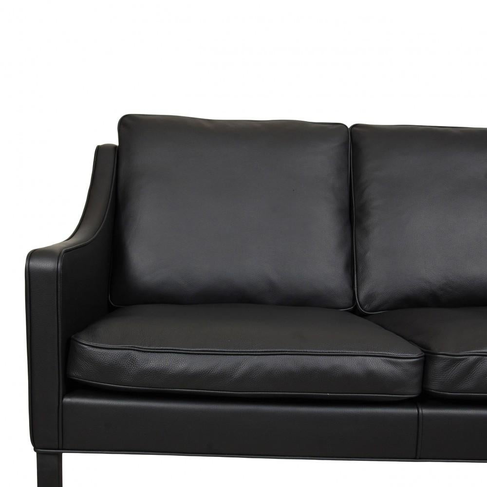 This sofa is used and appears newly upholstered in black bison leather and with black painted legs, and with new cushions. The sofa is original and produced by Fredericia Furniture. The upholstery is done according to the original methods.