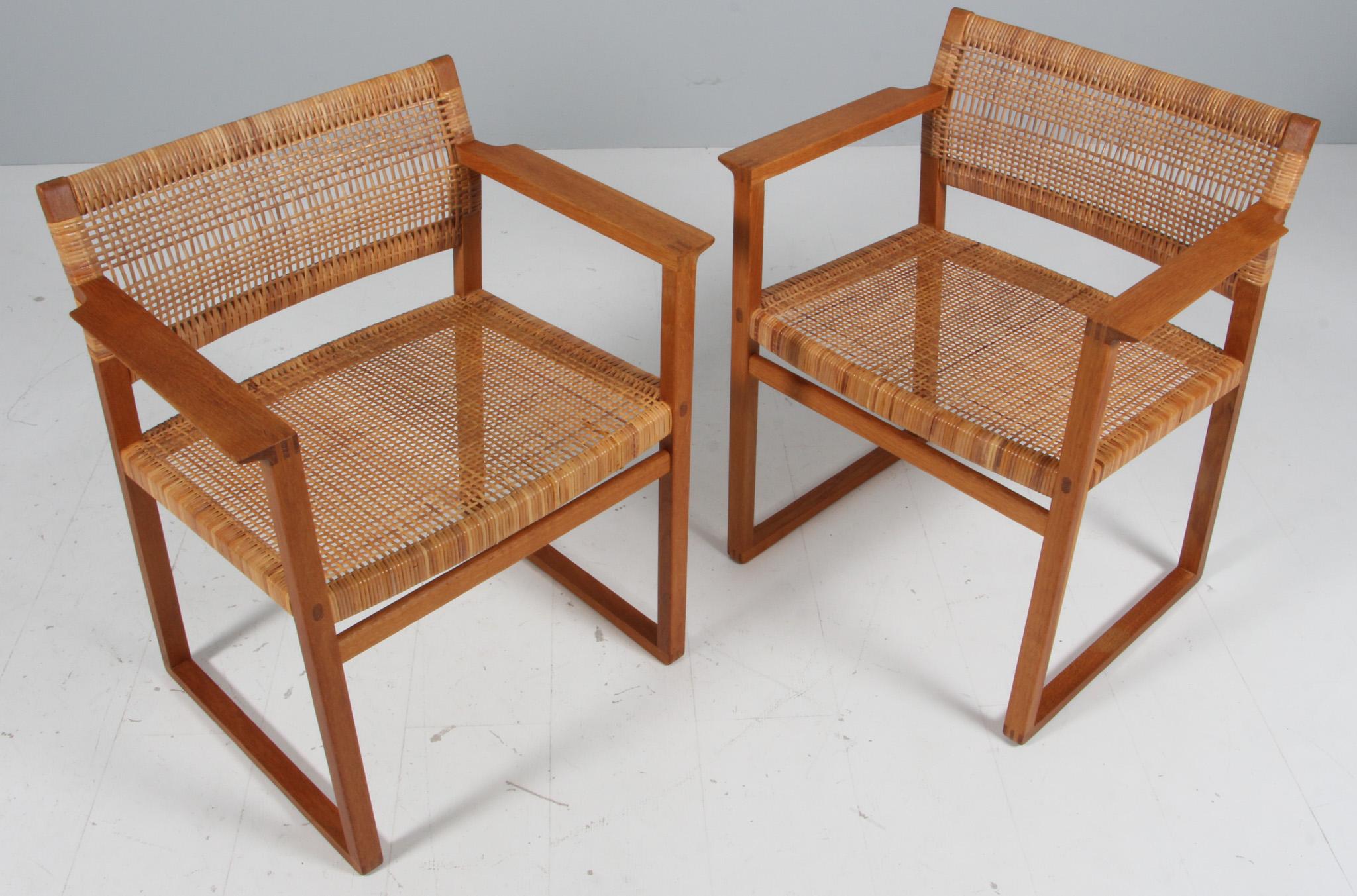 Børge Mogensen two arm chairs with seat of cane.

Frame of oak.

Made by C. M. Madsen. Model BM62.