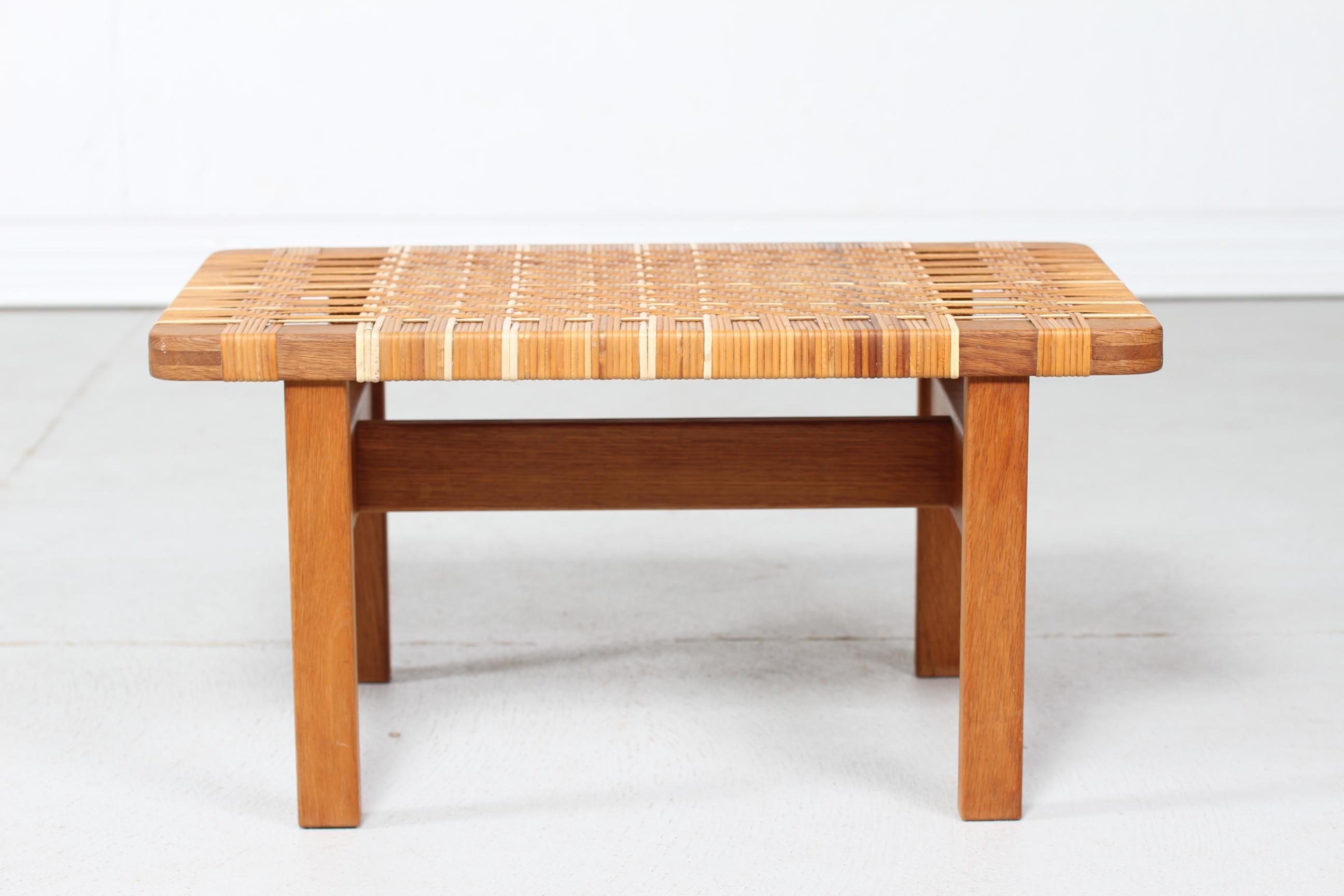 Low bench by Danish furniture designer Børge Mogensen (1914-1972) model BM 5273, manufactured by Fredericia Stolefabrik, Denmark.
The bench is made of solid oak with plaited cane.

Very nice vintage condition with beautiful patina. 
The plaiting