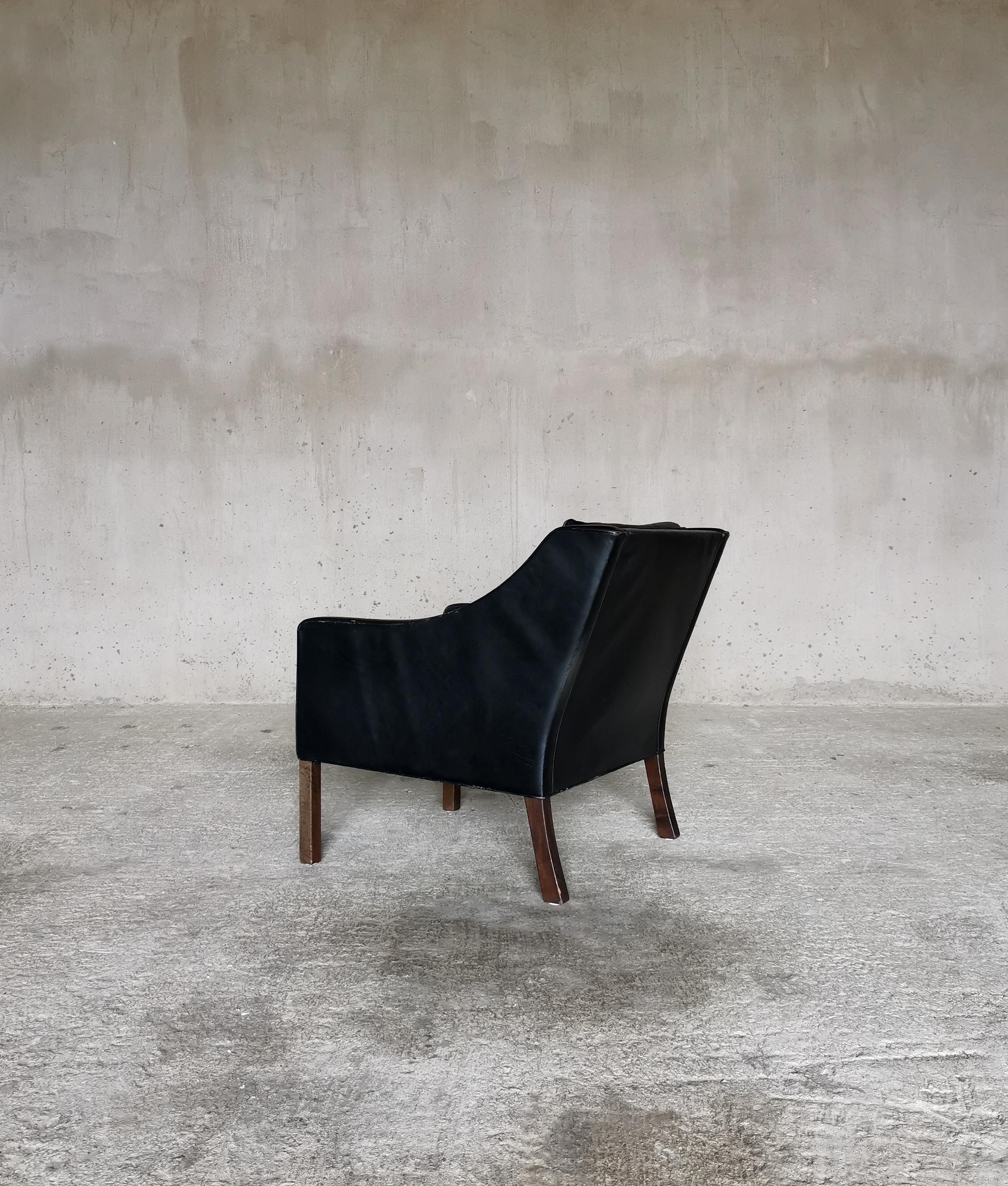 Børge Mogensen Black Leather Wingback model 2207 
With original patinated black leather upholstery.
Produced by Fredericia Furniture, Denmark 1960s
Dark stained beech legs
Manufactures stamp

This Chair is part of at set of three items, consisting