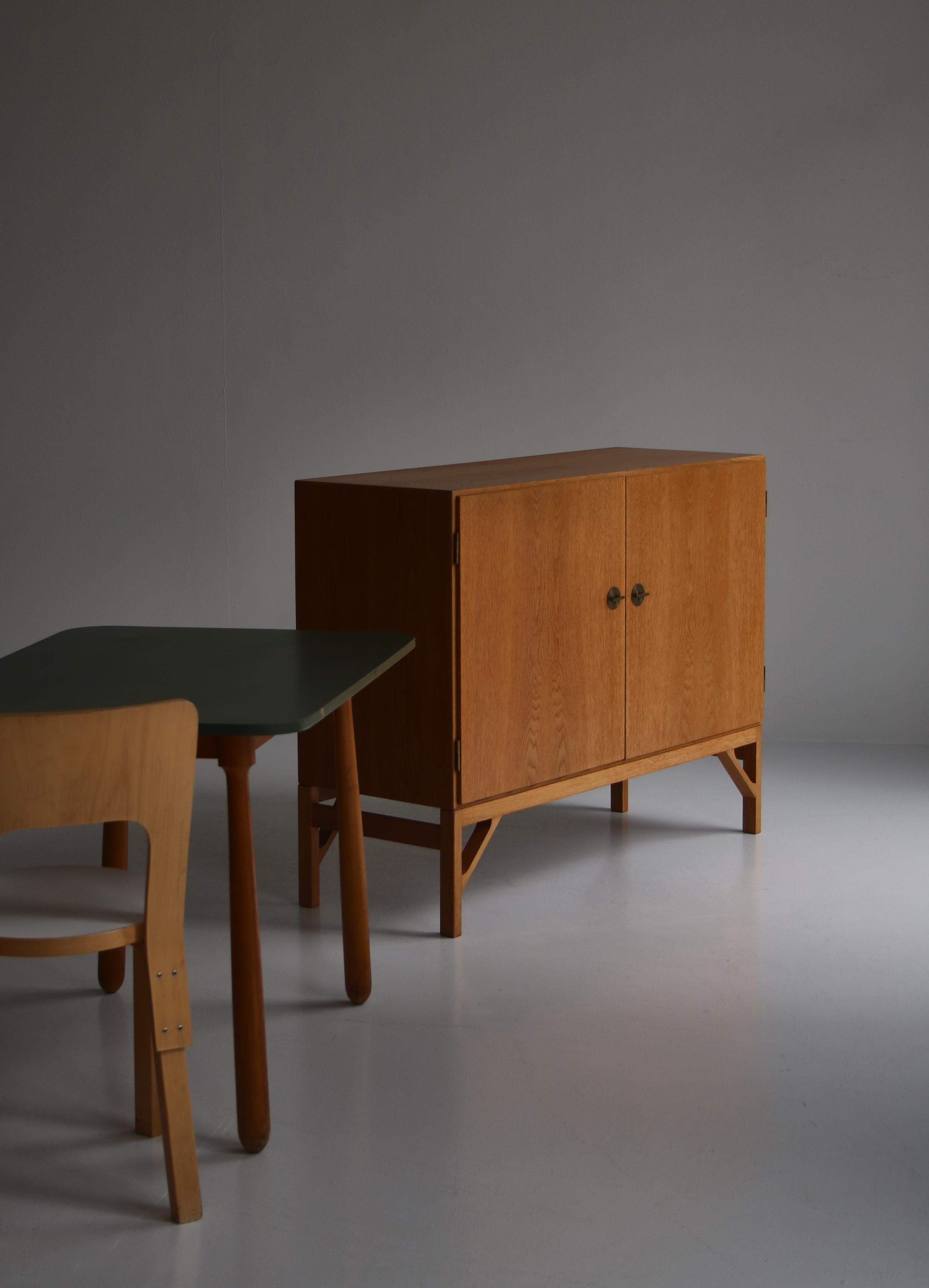 Wonderful 'China' cabinet all in oak with maple interior. Beautiful keys and handles in brass. Designed by Børge Mogensen in 1960 and produced by cabinetmaker C.M. Madsens for FDB Møbler, Denmark. This cabinet is beautifully patinated and has only