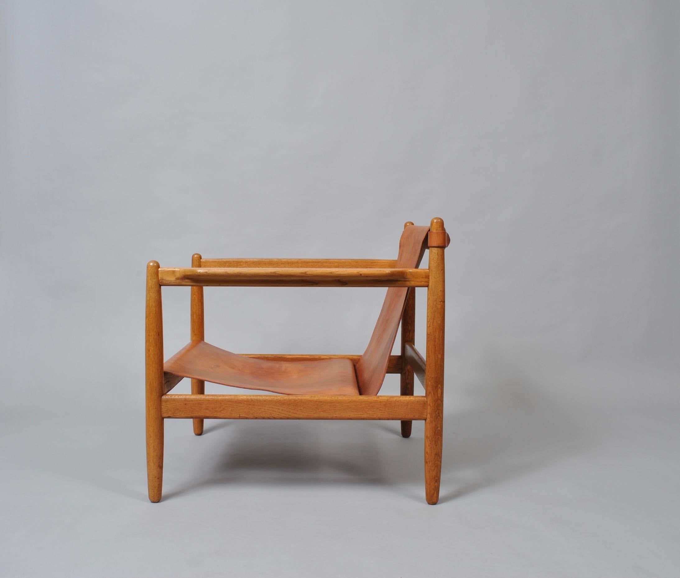 A rare lounge chair designed by Børge Mogensen for Karl Andersson. Constructed from European oak with slung tan saddle leather upholstery. This rarely available Oresund Bra-Bohag chair was produced by Karl Andersson and Sons in 1959, Sweden.