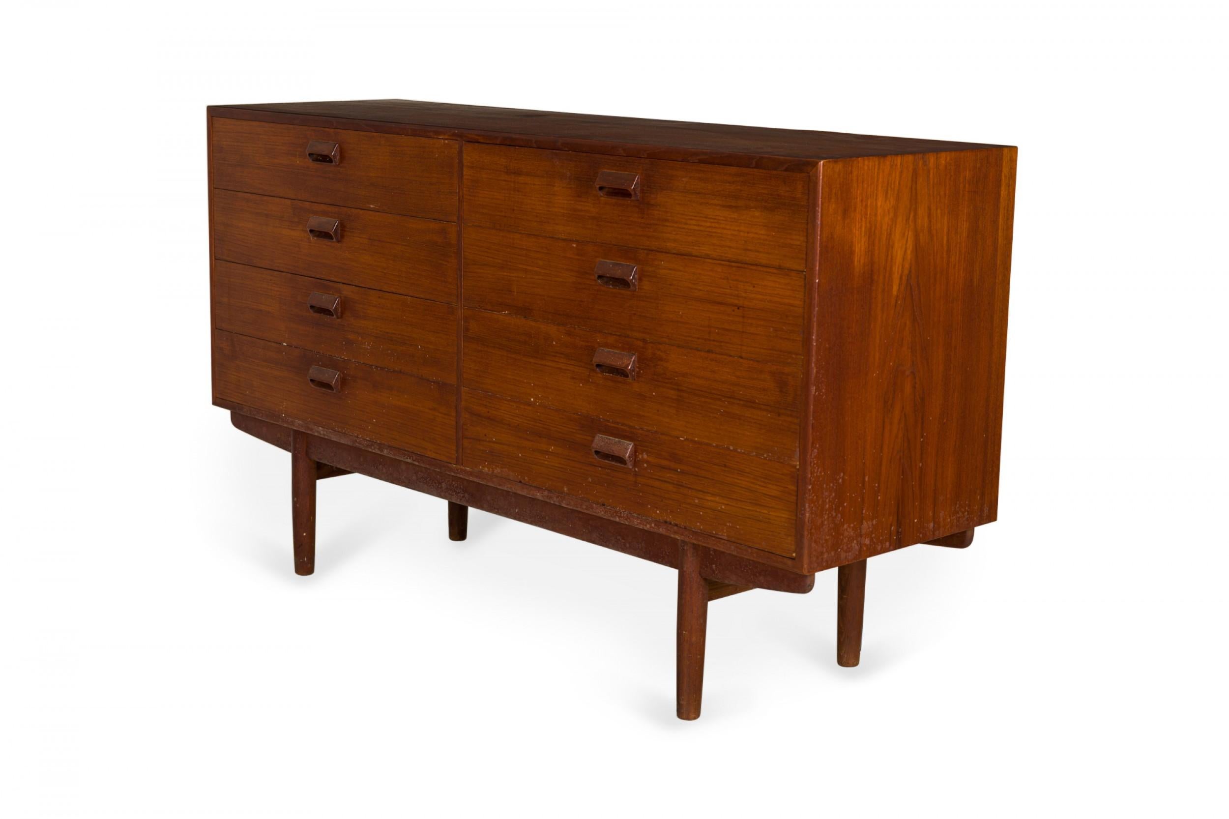 Danish mid-century teak eight-drawer chest with a rectangular cabinets, two sets of four drawers with inset drawer pulls, resting on four tapered teak legs. (BØRGE MOGENSEN)