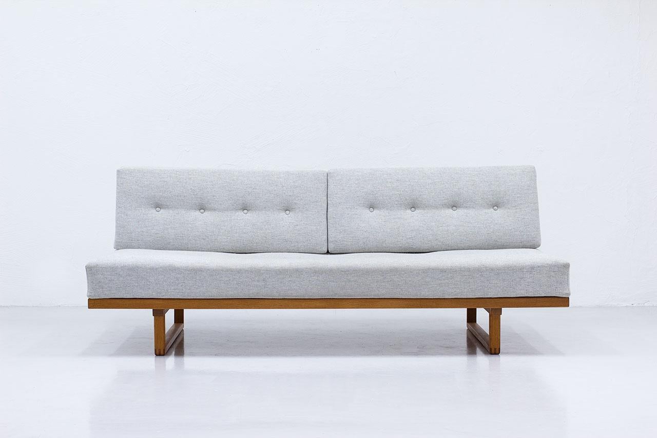 Large sofa, daybed model 4312 or model 312 designed by Danish, Børge Mogensen in 1958. Manufactured in Denmark by Fredericia Stolefabrik.
Made from solid oak frame with loose cushions and mattress, brass details.
The deep buttoned loose cushions