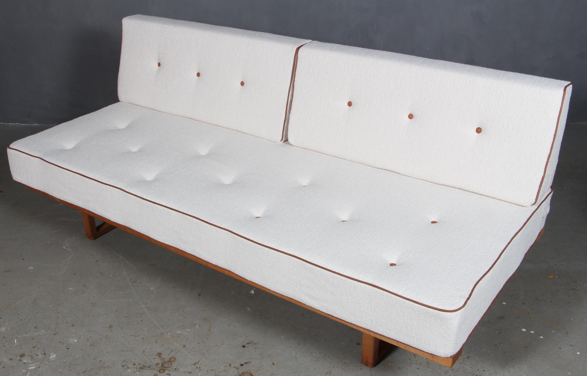 Børge Mogensen daybed / sofa with frame of soap treated oak.

New upholstered with boucle wool and leather piping and buttons.