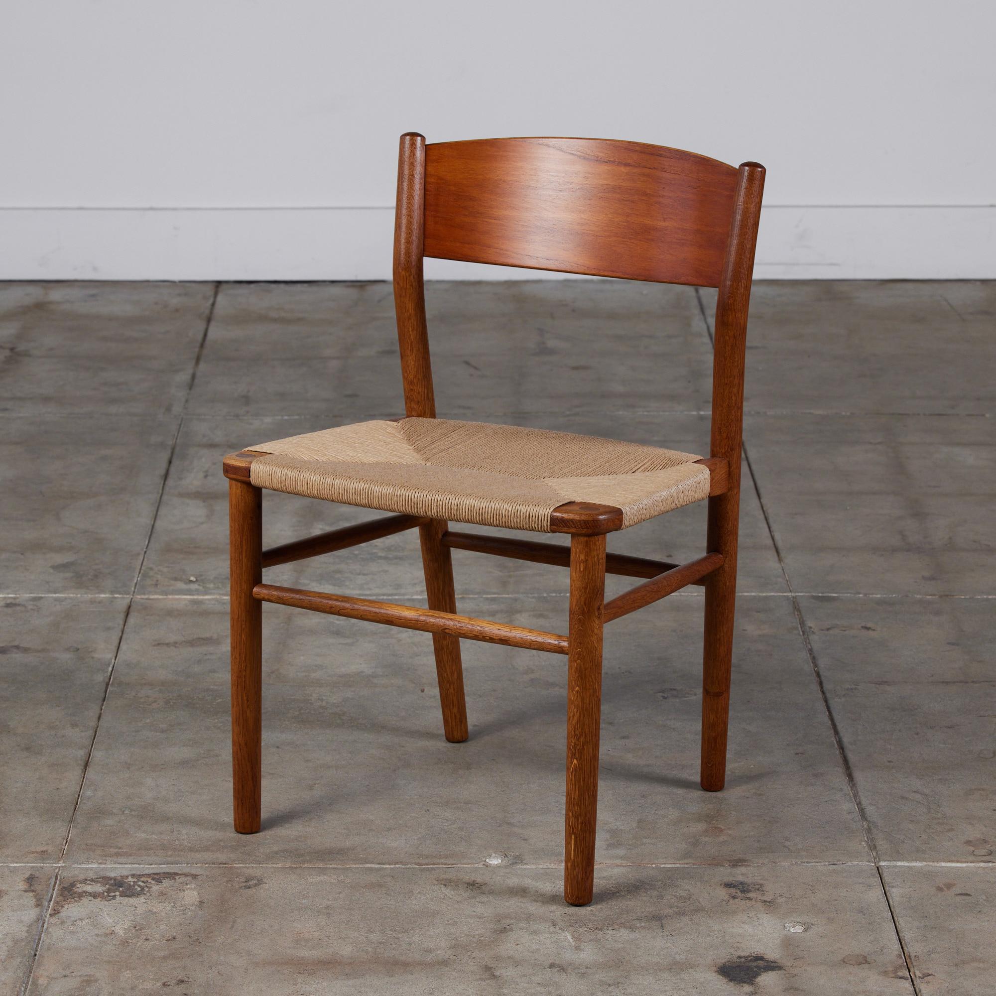 Teak desk or side chair by Børge Mogensen for FDB Møbler beginning in 1947. The chair has a wide, curved backrest and a woven seat in natural Danish paper cord. 

Dimensions: 19.75” width x 19.5” depth x 29.75” height; seat height is 17.75”
