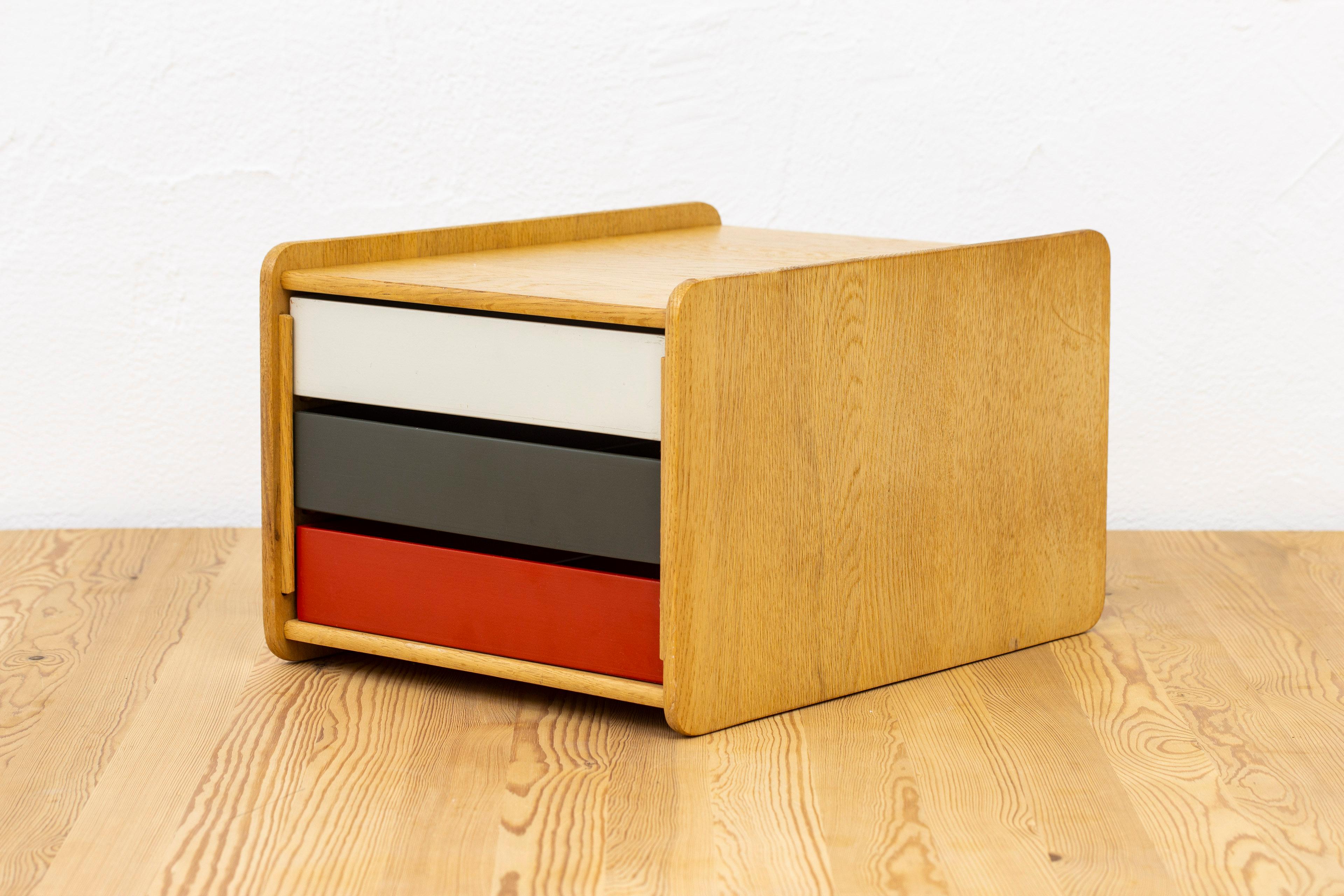 Desk organizer designed by Børge Mogensen. Produced in Sweden by Karl Andersson & Söner during the 1950s. Made from solid light oak with insert boxes in red, white and grey/green painted wood. Very good vintage condition with some age related wear