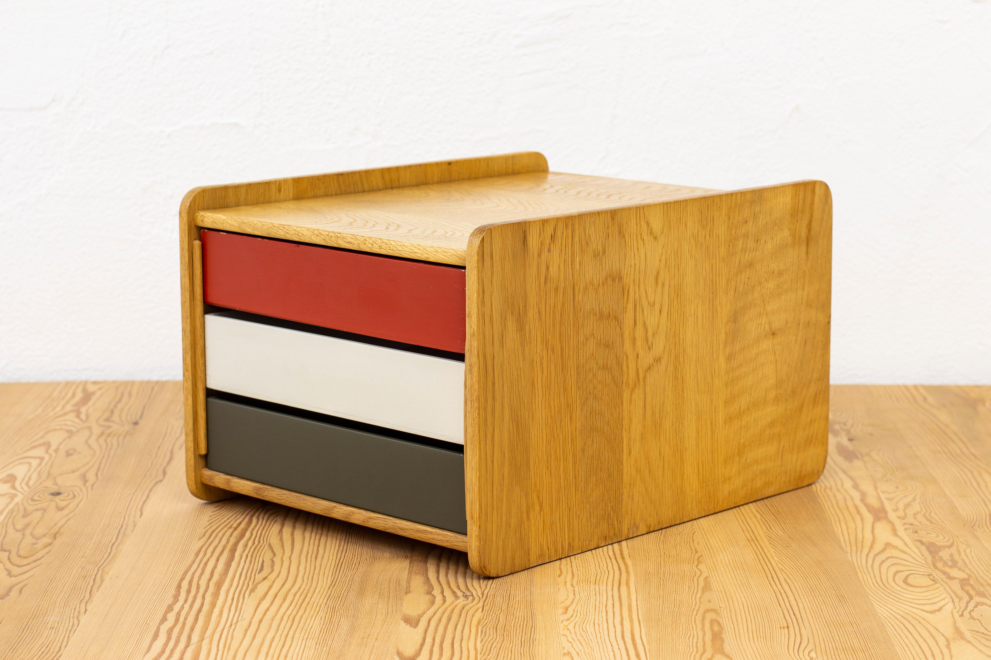 Desk organizer designed by Børge Mogensen. Produced in Sweden by Karl Andersson & Söner during the 1950s. Made from solid light oak with insert boxes in red, white and grey/green painted wood. Good vintage condition with some age related wear and