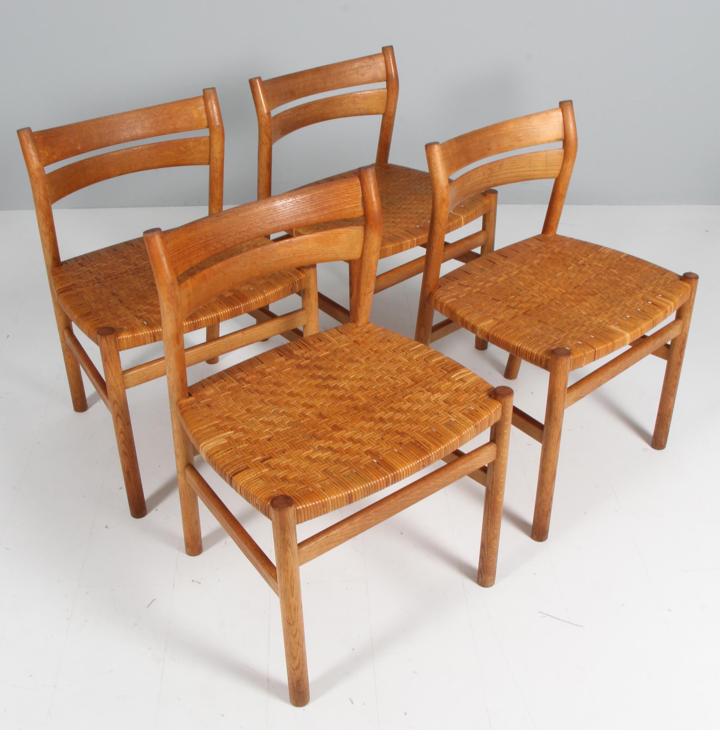 Børge Mogensen set of four dining chairs with seat of cane.

Frame of oak.

Made by C. M. Madsen. Model BM1.