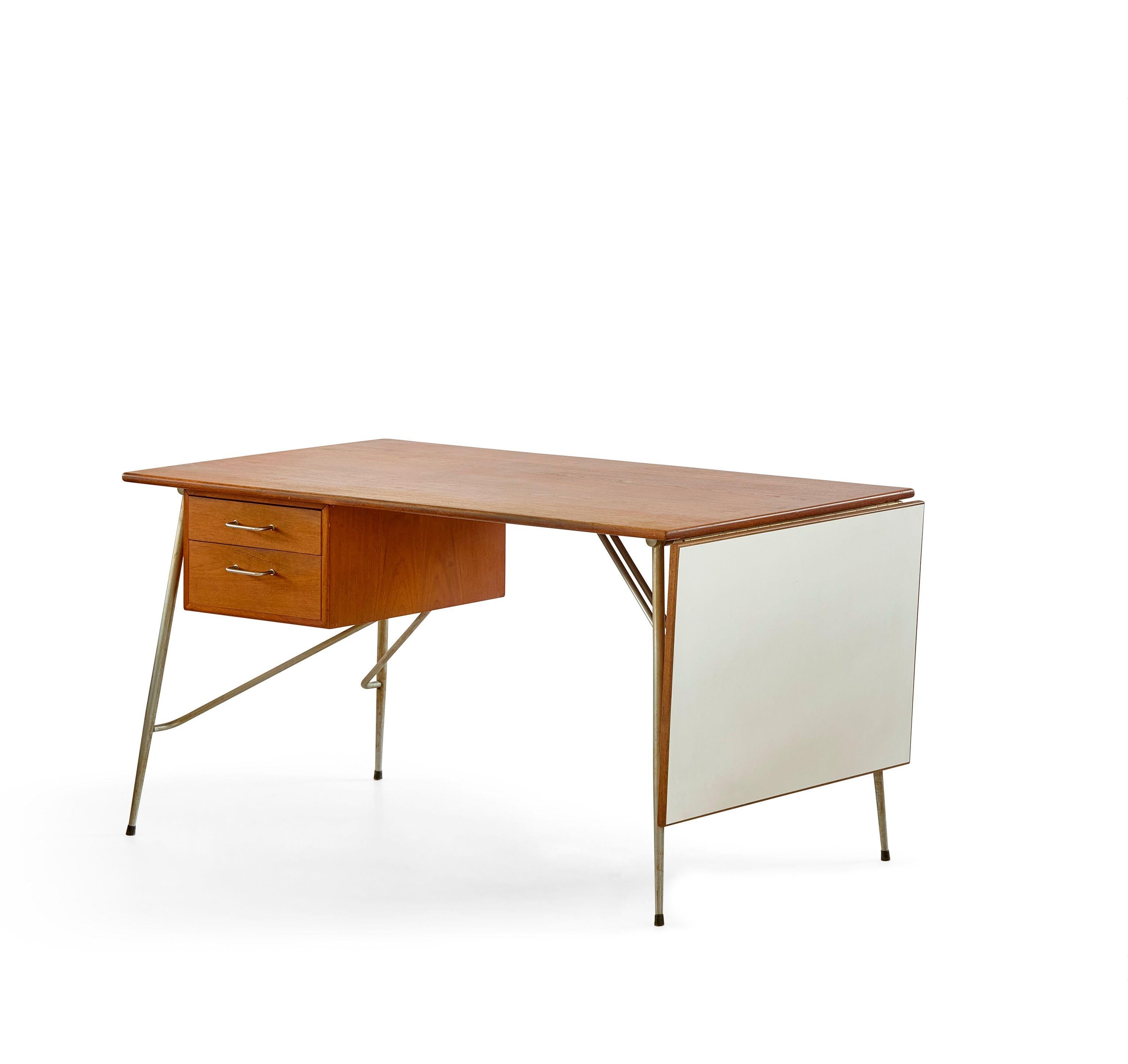 A really special drop-leaf desk by Børge Mogensen for Søborg Mobler, Denmark. 
This example produced in teak with a stainless steel base and a very rare White laminate drop-leaf.      These are typical seen with a standard teak drop -leaf but this