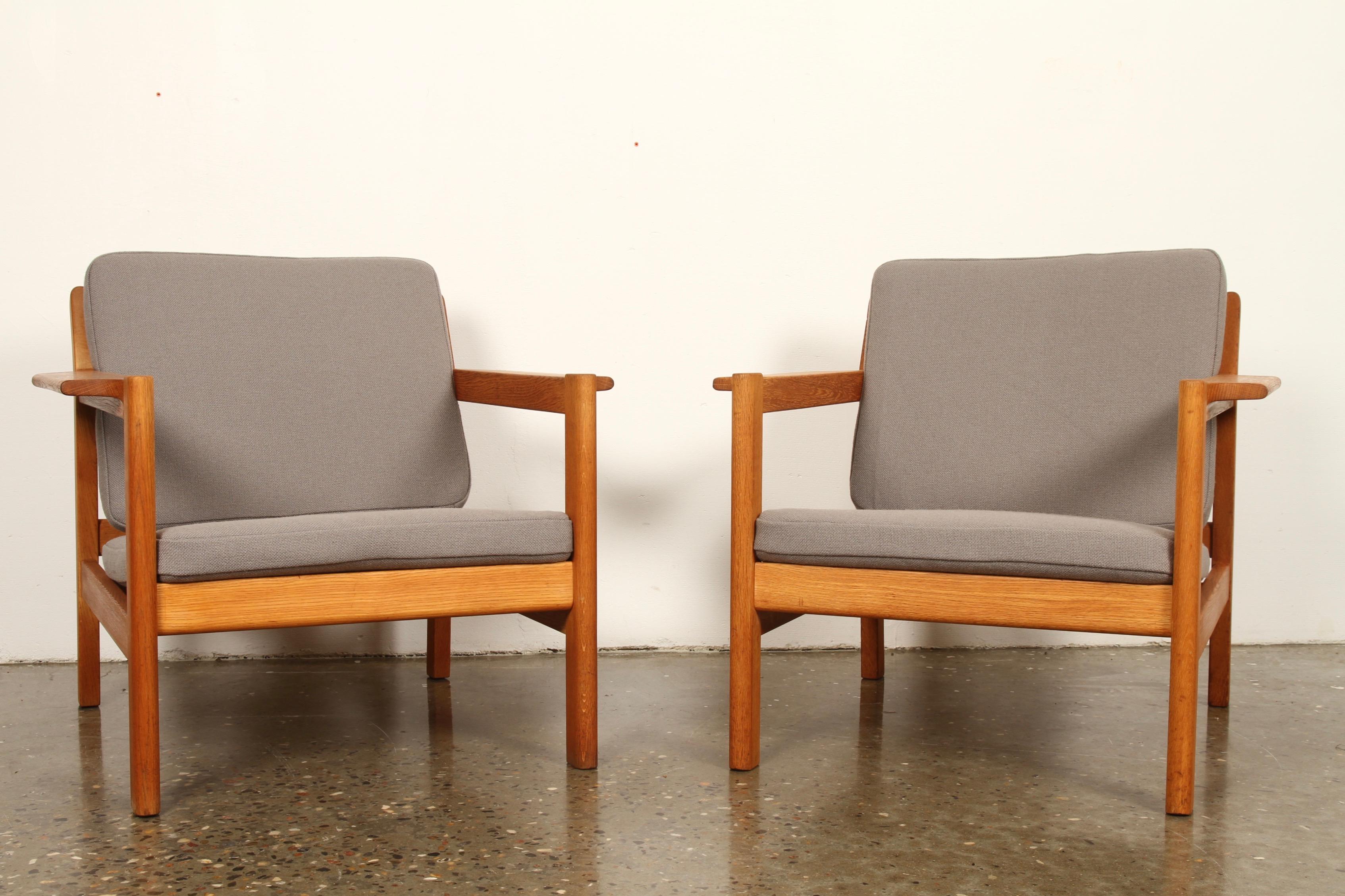 Danish modern lounge chairs by Børge Mogensen for Fredericia Stolefabrik. Restored oiled solid oak frame. Brand new custom made cushions in Hallingdal Wool and new seat straps. Good quality danish vintage armchairs.