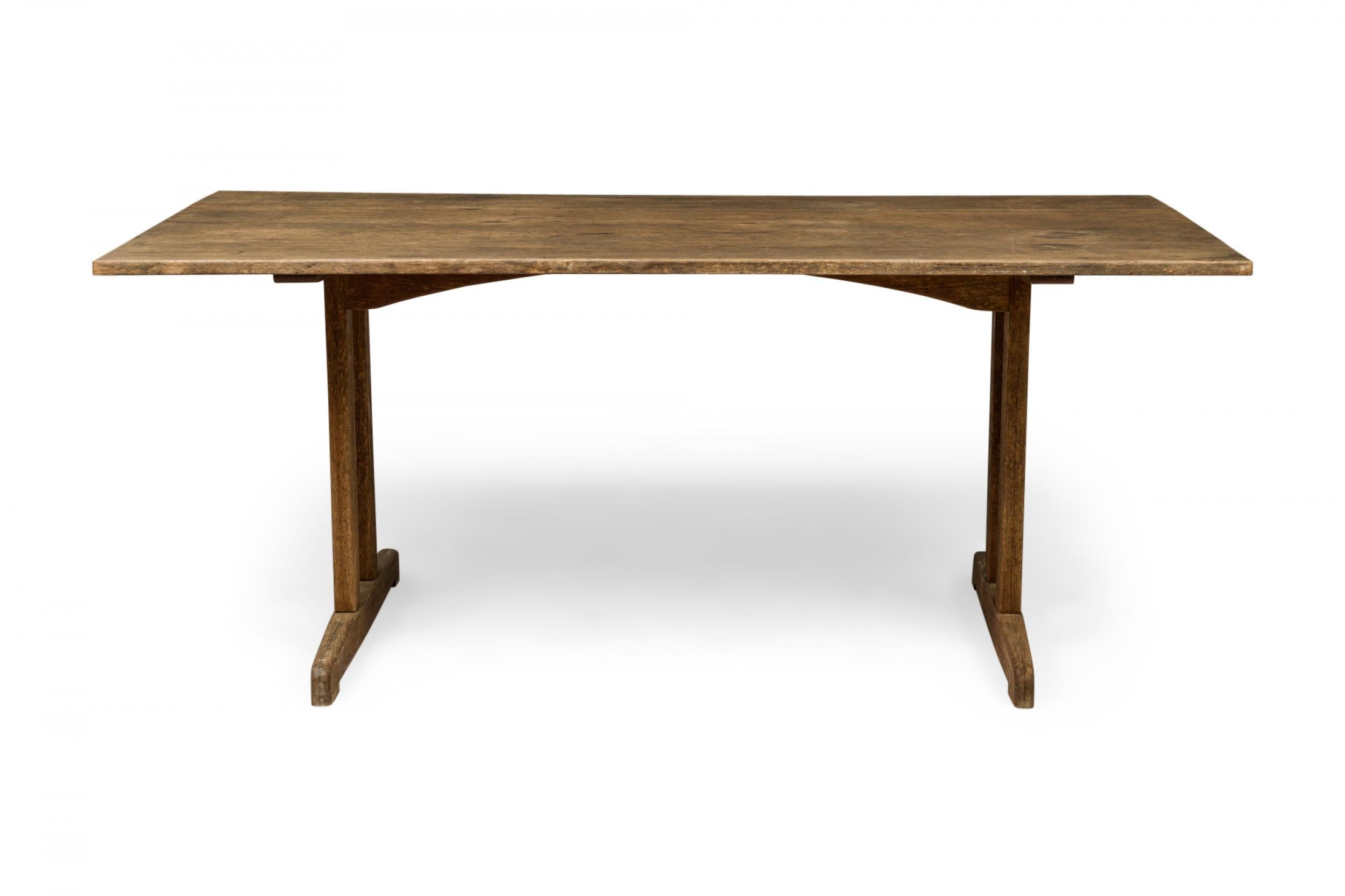 Danish mid-century Shaker-style wooden dining table with a rectangular wooden top resting on two double T-shaped legs. (BØRGE MOGENSEN FOR FDB MØBLER)