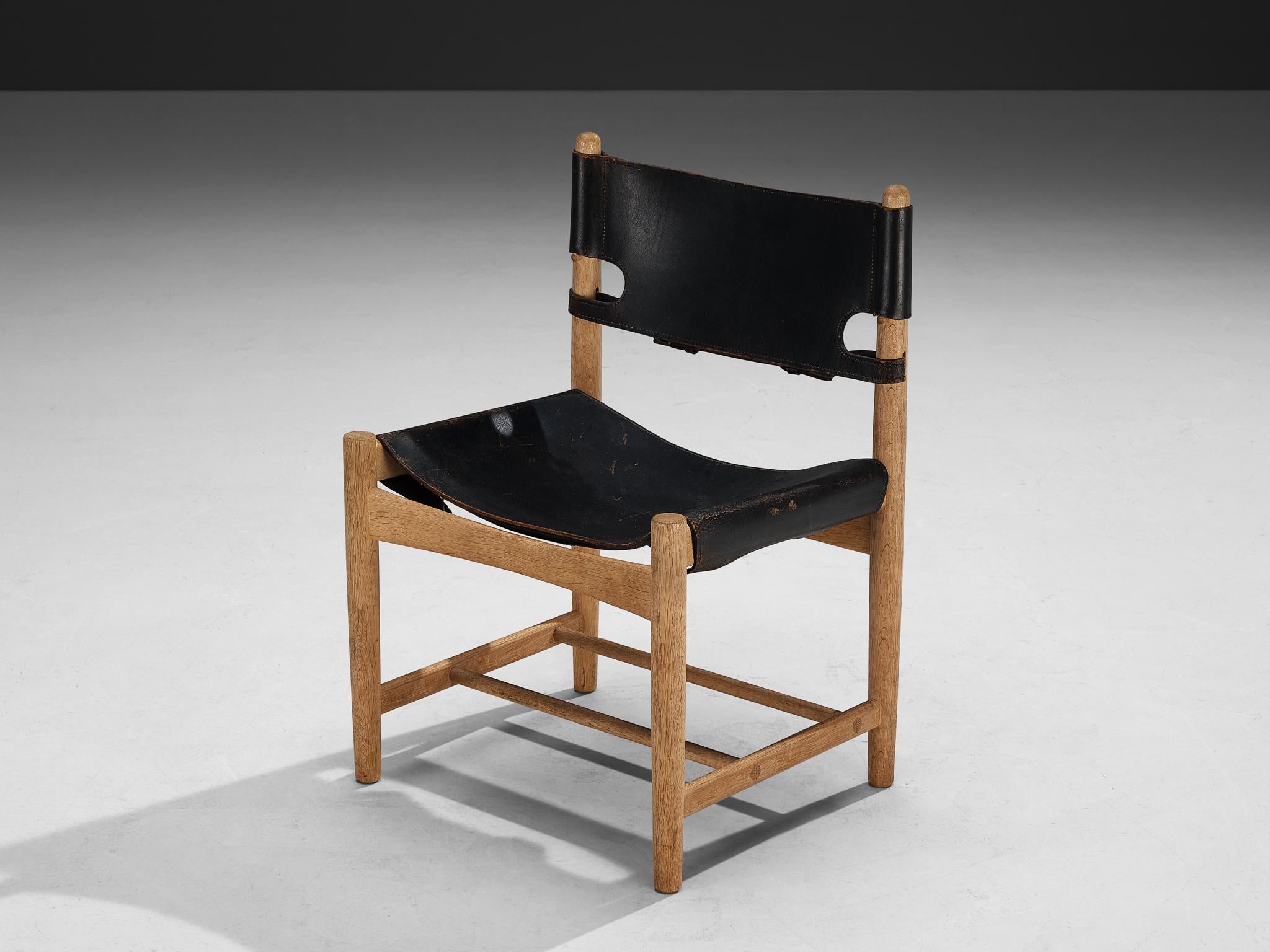 Børge Mogensen for Fredericia Stolefabrik, armchair, model '3237', oak, leather, metal, Denmark, 1964.

This armchair reminds of the classical foldable 'director-chairs', yet this design by Danish designer Børge Mogensen (1914-1972) is from a more