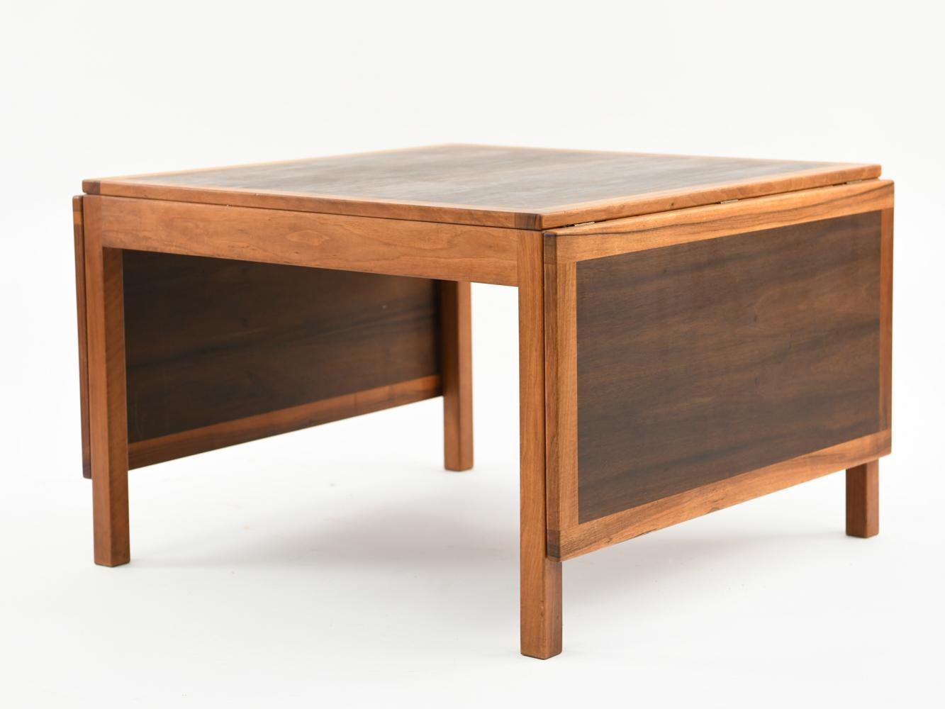 A Danish midcentury coffee table designed by Børge Mogensen for Fredericia in the 1960s. This table is model 5362/574 and cleverly features two drop leaves that allow the table to expand or contract depending on available interior space.