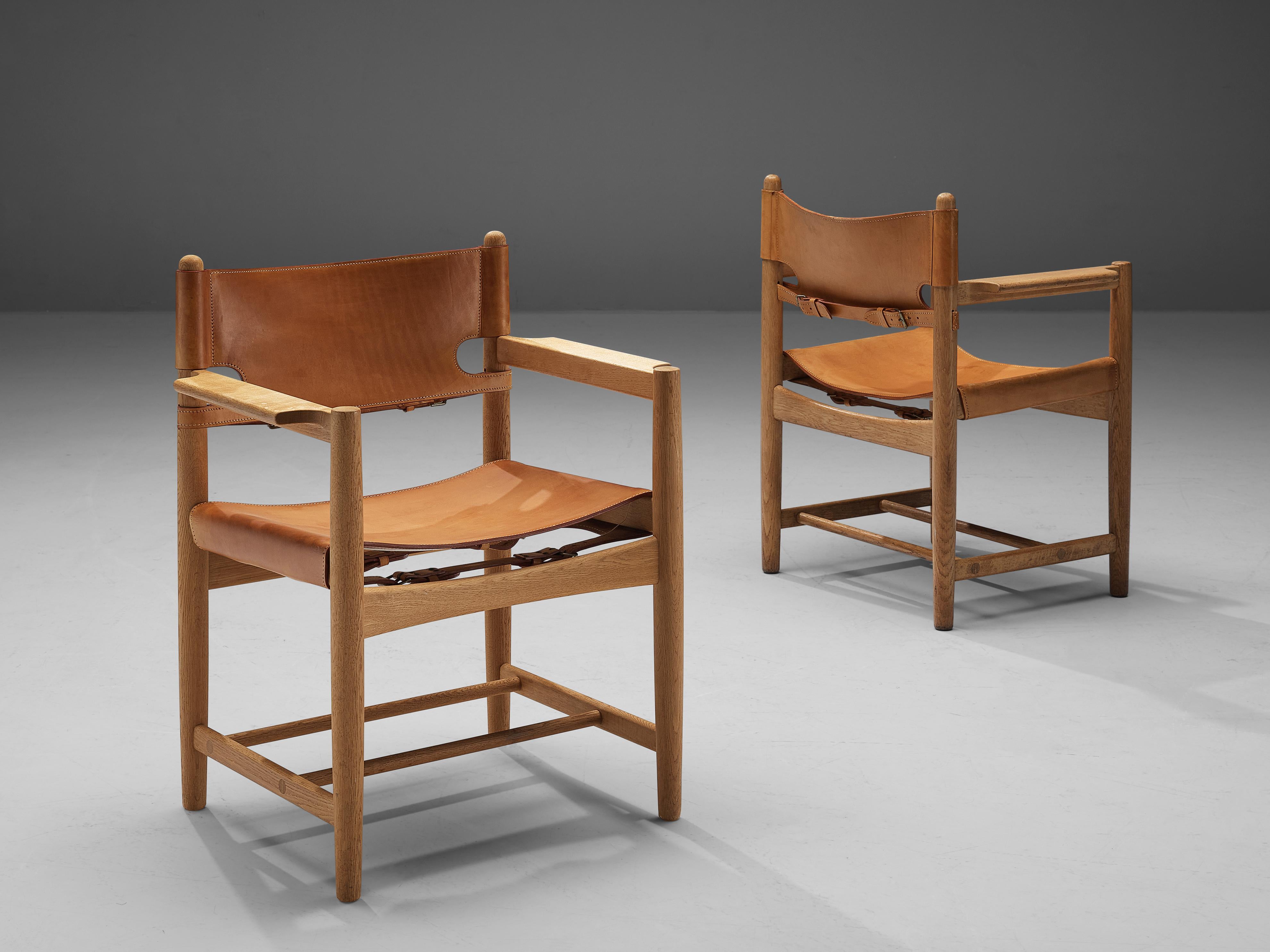 Børge Mogensen for Fredericia Stolefabrik, pair of armchairs model 3237, oak, leather, Denmark, 1964.

This pair of armchairs reminds of the classical foldable 'director-chairs', yet this design by Danish designer Børge Mogensen (1914-1972) is
