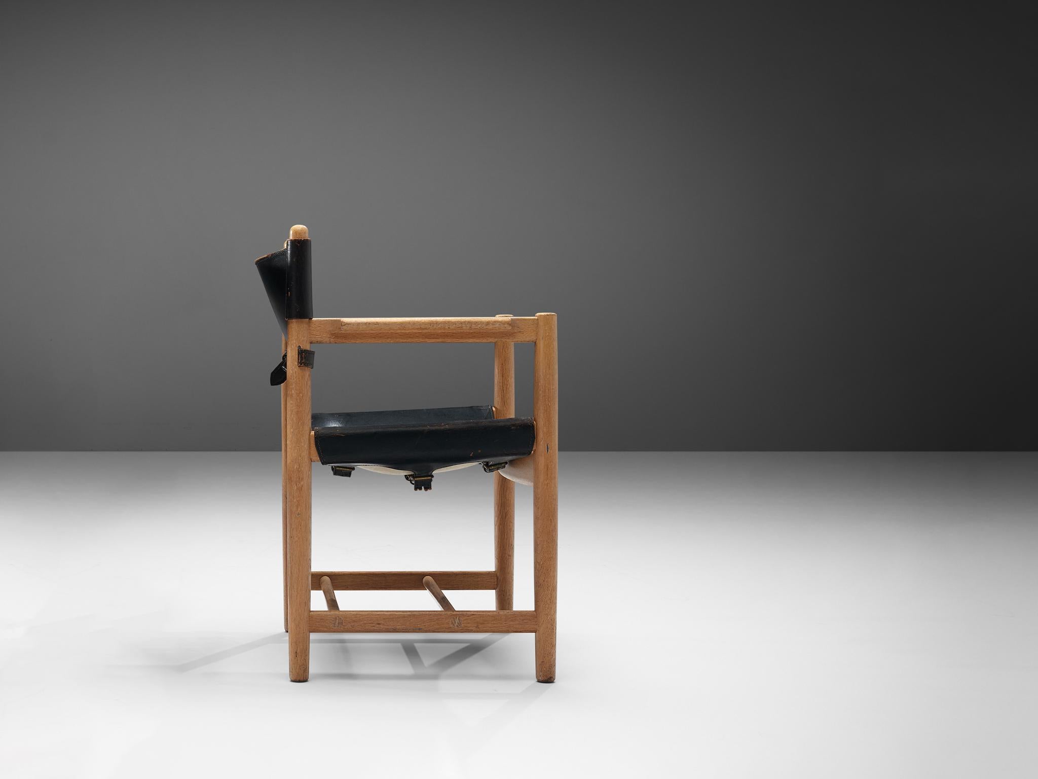 Børge Mogensen for Fredericia Stolefabrik, 'Spanish Dining Chair' model 3238, oak, black leather, Denmark, 1964.

This chair reminds of the classical foldable 'director-chair', yet this design by Danish designer Børge Mogensen (1914-1972) is from