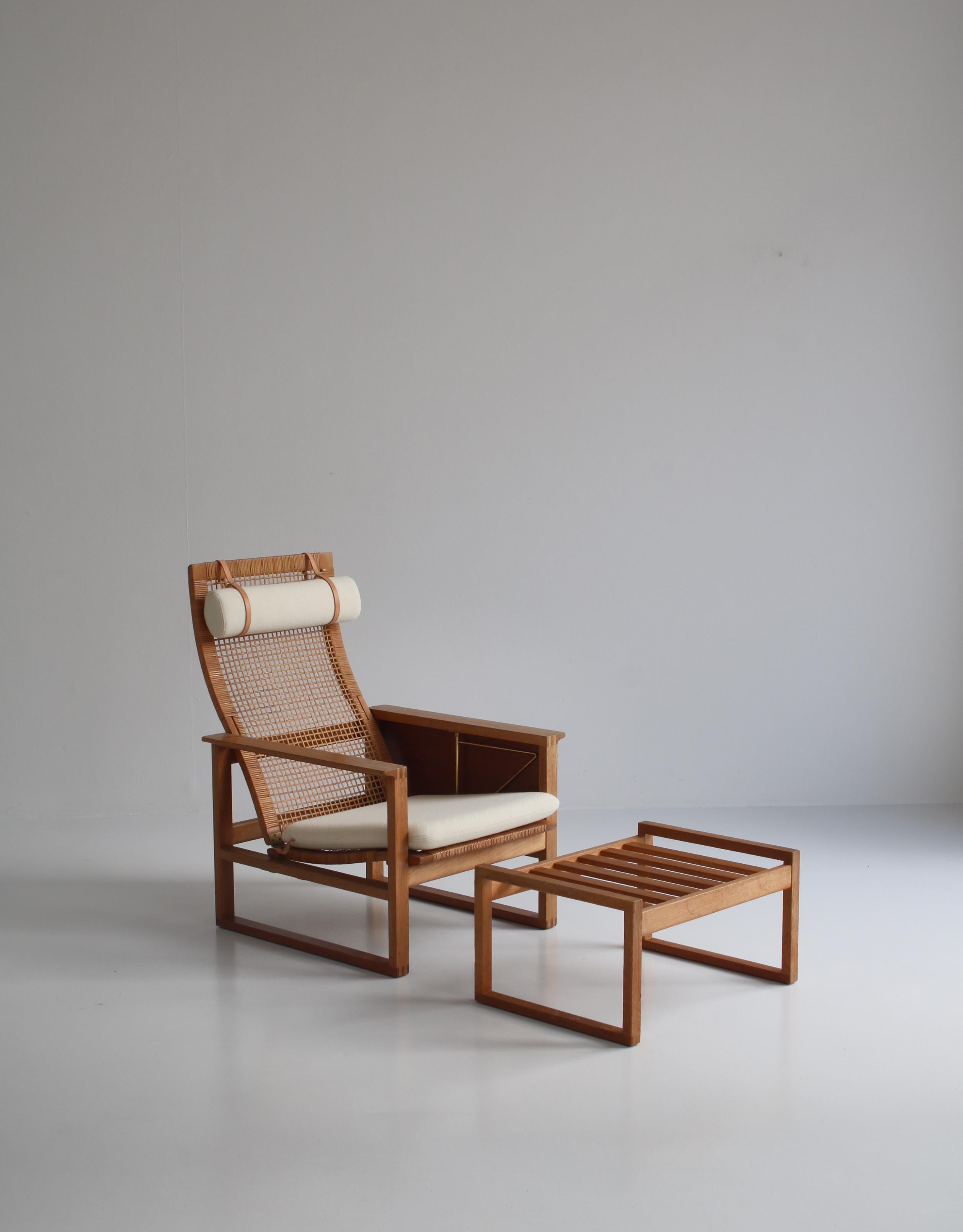 Early and important chair by Børge Mogensen. This very rare model 244 features rattan cane on seat and back and solid teakwood sledge base attached to the oak construction with finger joints. It comes with the original folding table in teakwood with