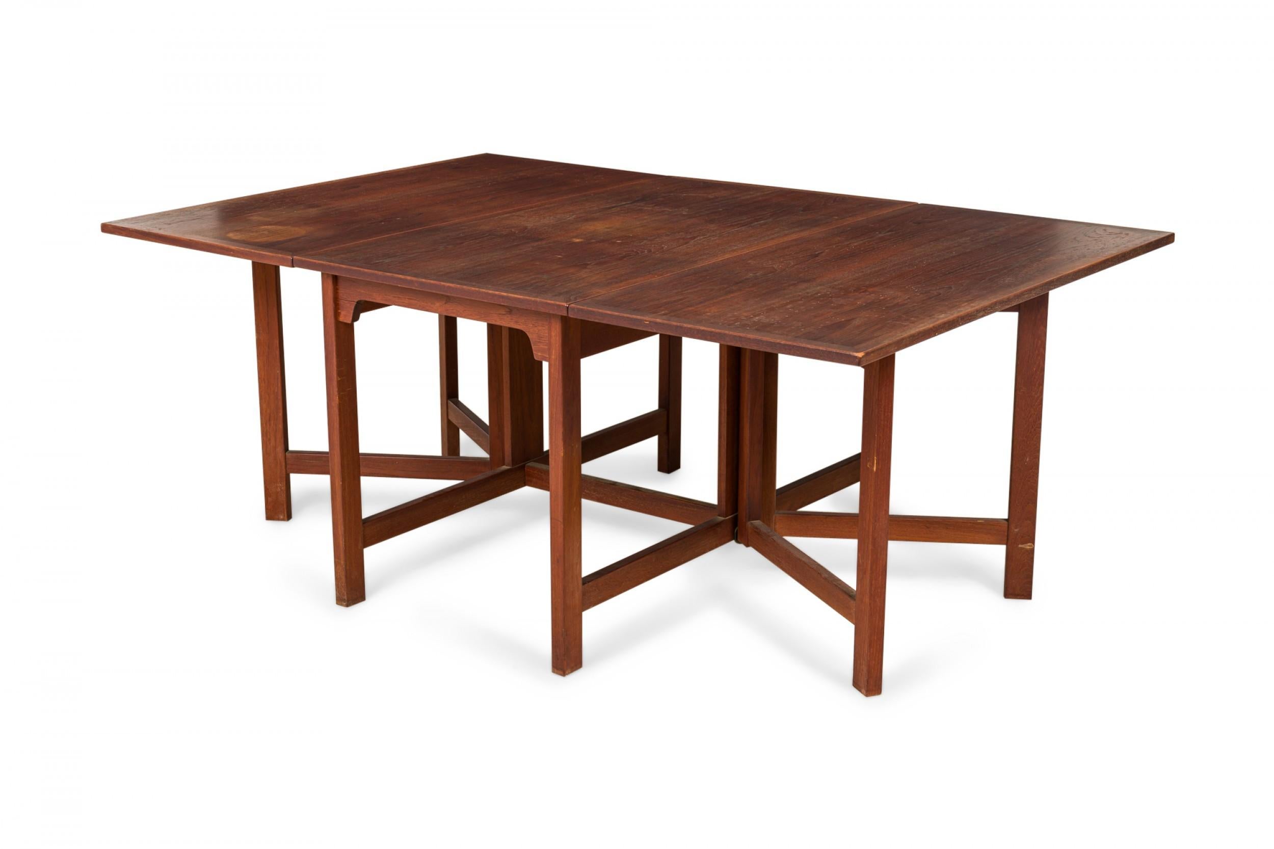 Danish Mid-Century 3-piece teak dining table set comprised of a center rectangular drop leaf table and two demilune tables that can be arranged to create a single large oval dining table, or can be used independently of one another. (BØRGE MOGENSEN,