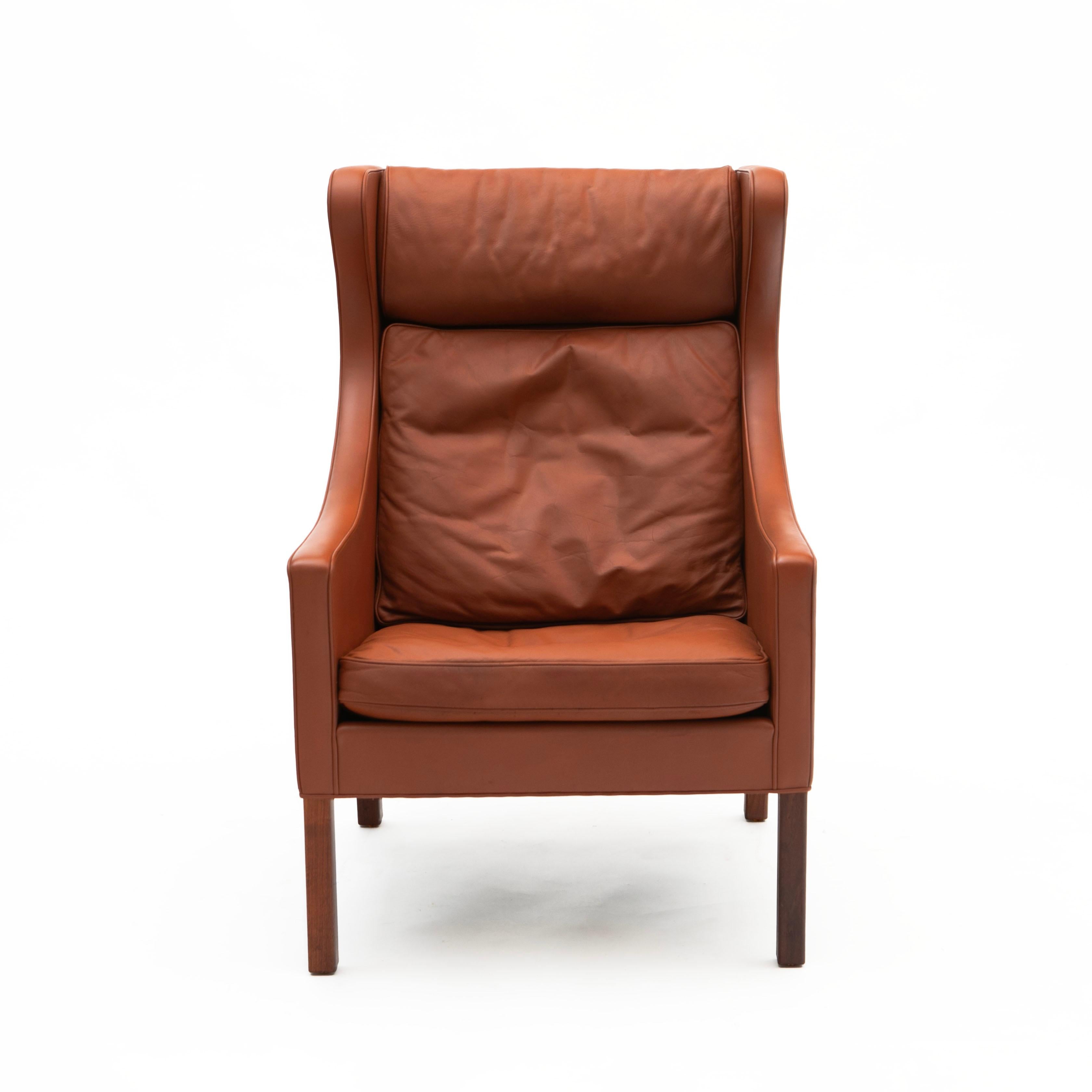 Børge Mogensen, Danish 1914-1972
High back wingchair in cognac colored leather and mahogany legs.

Designed by Børge Mogensen, manufactured by Fredericia in Denmark, 1960's. Model no. 2204/N2, serie no. 1175.

In very good original vintage