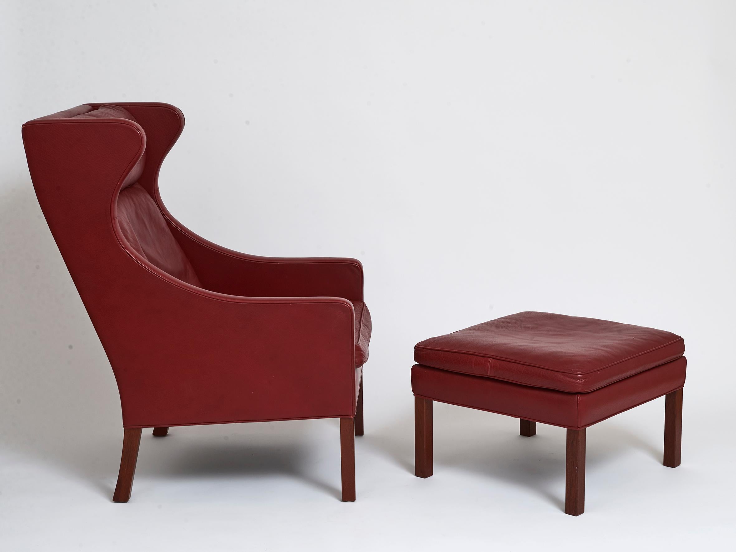 A Danish armchair and footstool in rich burgundy leather and stained beech legs. Designed by Børge Mogensen and produced by A/S Fredericia Stolefabrik
Original design 1963. This set from 1980s
Footstool measurements 40.5cm high 60cm square.

 