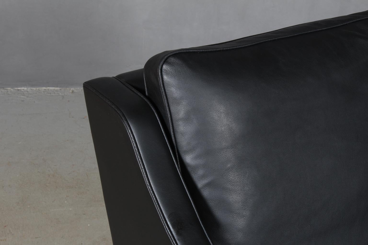 Børge Mogensen lounge chair new upholstered with black aniline leather.

Legs of teak.

Model 2207, made by Fredericia furniture.