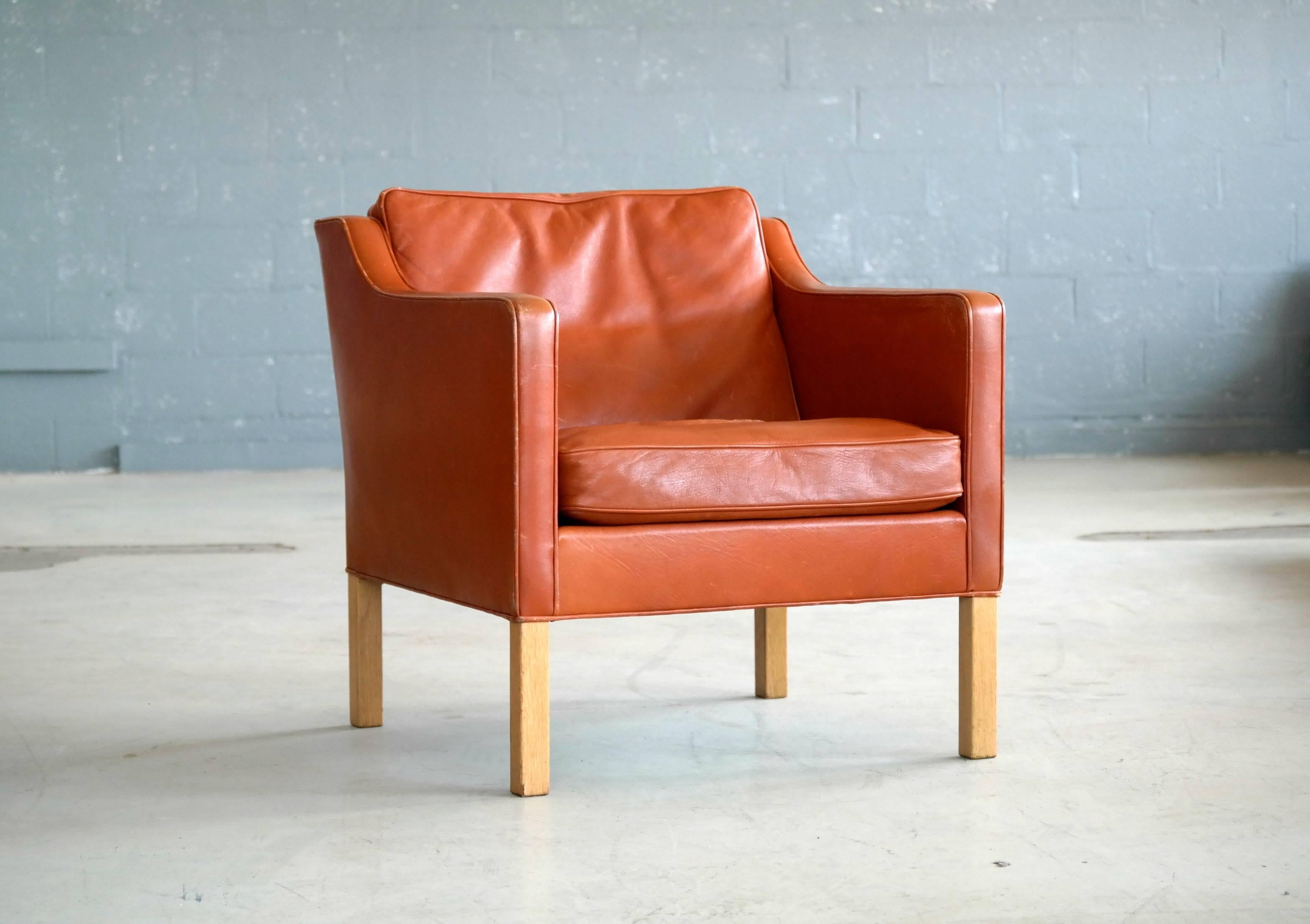 Stunning Børge Mogensen designed lounge chair model 2421 for Fredericia. One of the most elegant Classic midcentury Danish lounge chairs ever made of a design that will just never go out of style. Supple cognac colored leather with down-filled