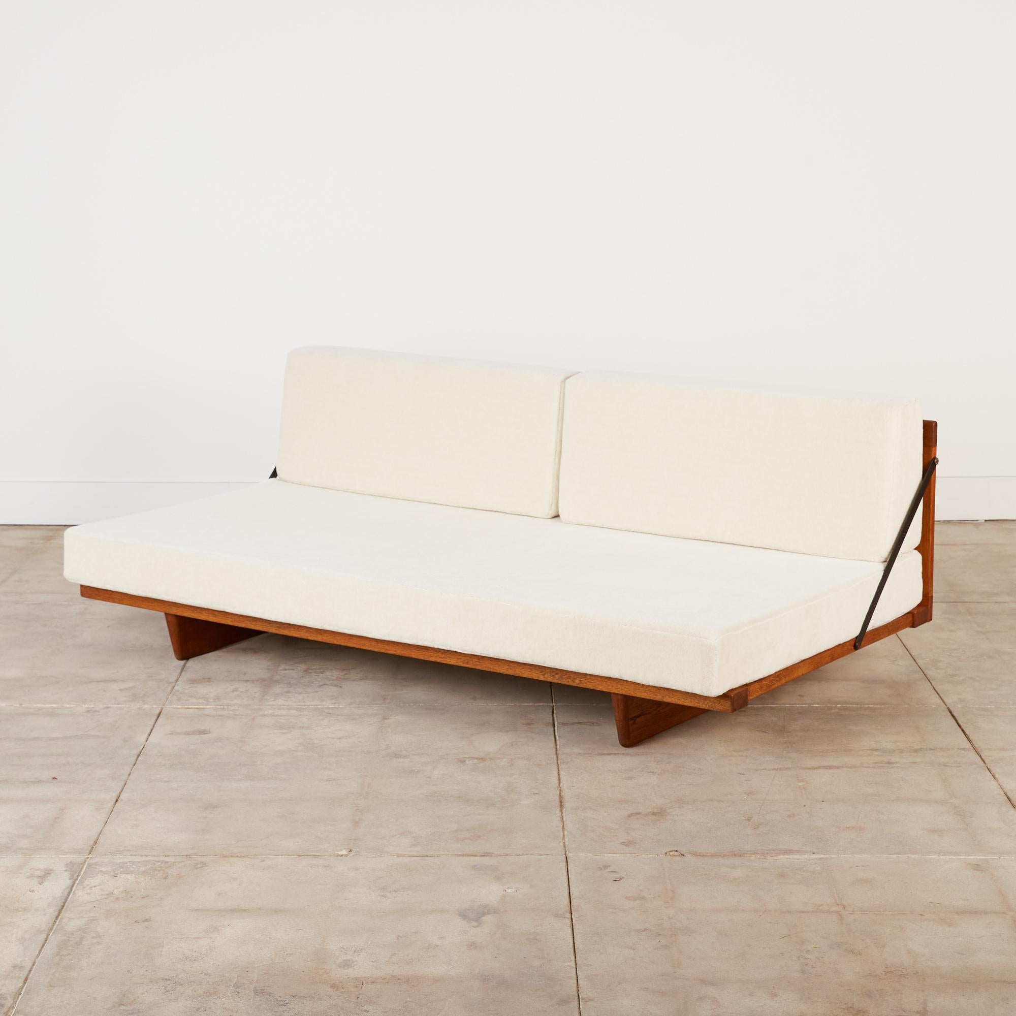 Børge Mogensen Model 192 daybed for Fredericia Stolefabrik, Denmark, c.1950s. This rare 1955 design features an oiled oak frame with slatted wood back and diagonal flat metal bars which serve as side supports. It has seat and back cushions covered