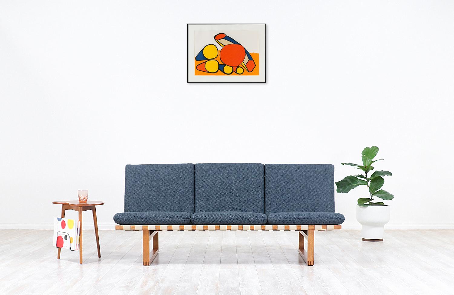Early vintage model 211 sofa designed by brilliant Danish architect Børge Mogensen in collaboration with the workshop of Fredericia Stolefabrik in Denmark during the 1950s. Mogensen's philosophy for this line was servicing functionalism and comfort