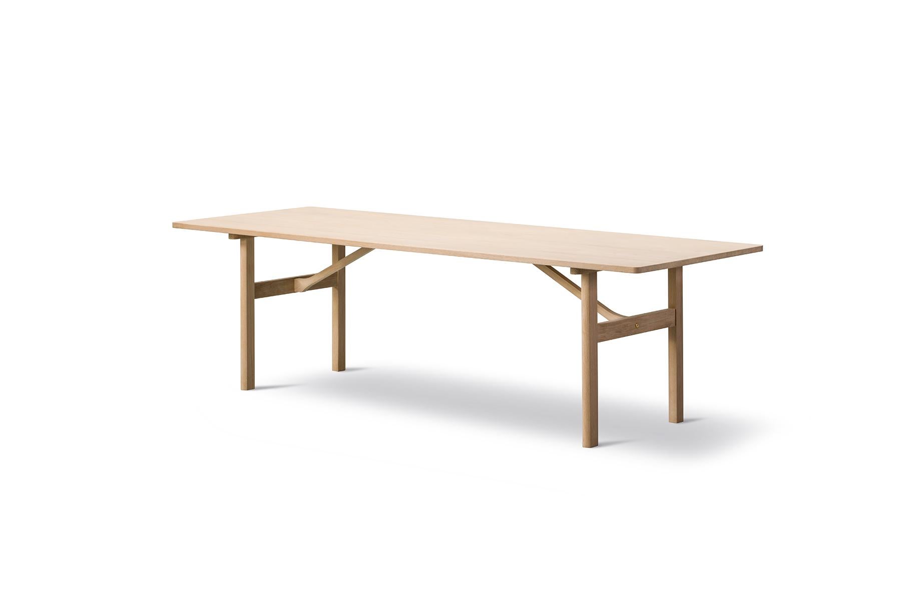 Børge Mogensen Model 6384 dining table designed in 1958, this dining table is constructed from the finest selection of solid oak. Also available with additional plates extending the tabletop by 40 cm at each end.