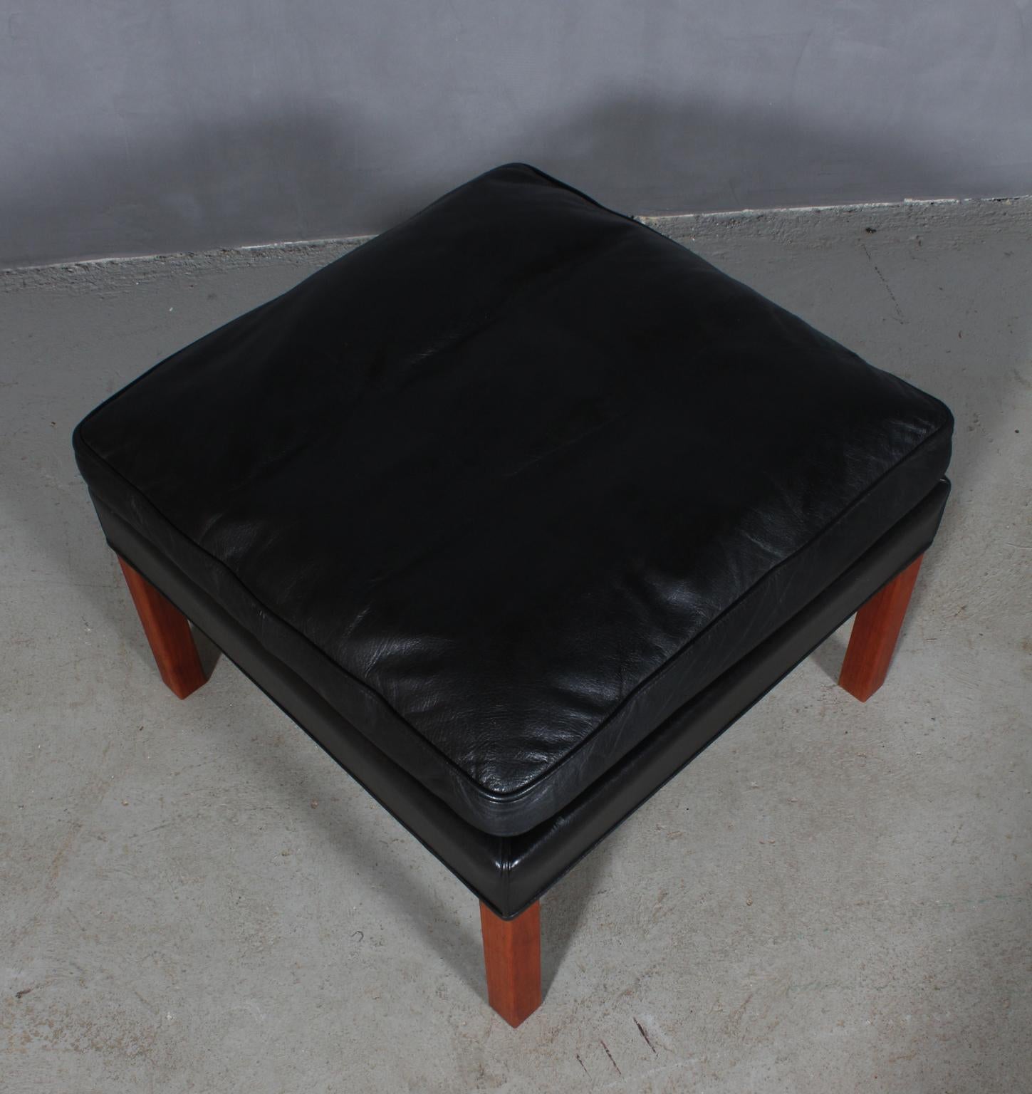 Børge Mogensen ottoman original upholstered with black leather.

Legs of teak.

Model 2202, made by Fredericia Furniture.