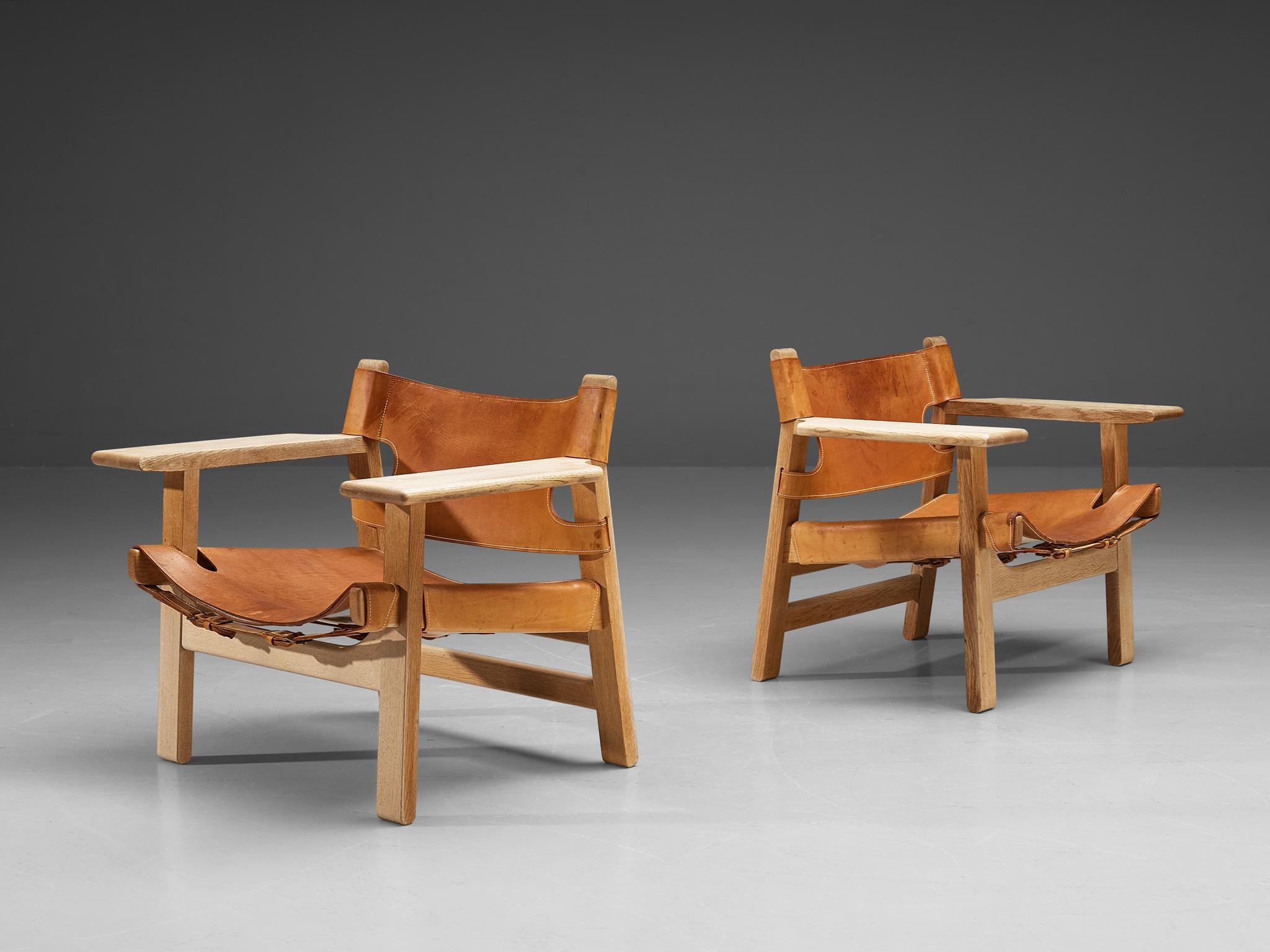 Børge Mogensen for Fredericia Stolefabrik, pair of two 'Spanish Chairs,' solid oak, metal and cognac leather, Denmark, 1958.

This well-known design by Børge Mogensen has a very strong appearance. The sincere construction and type of upholstery,