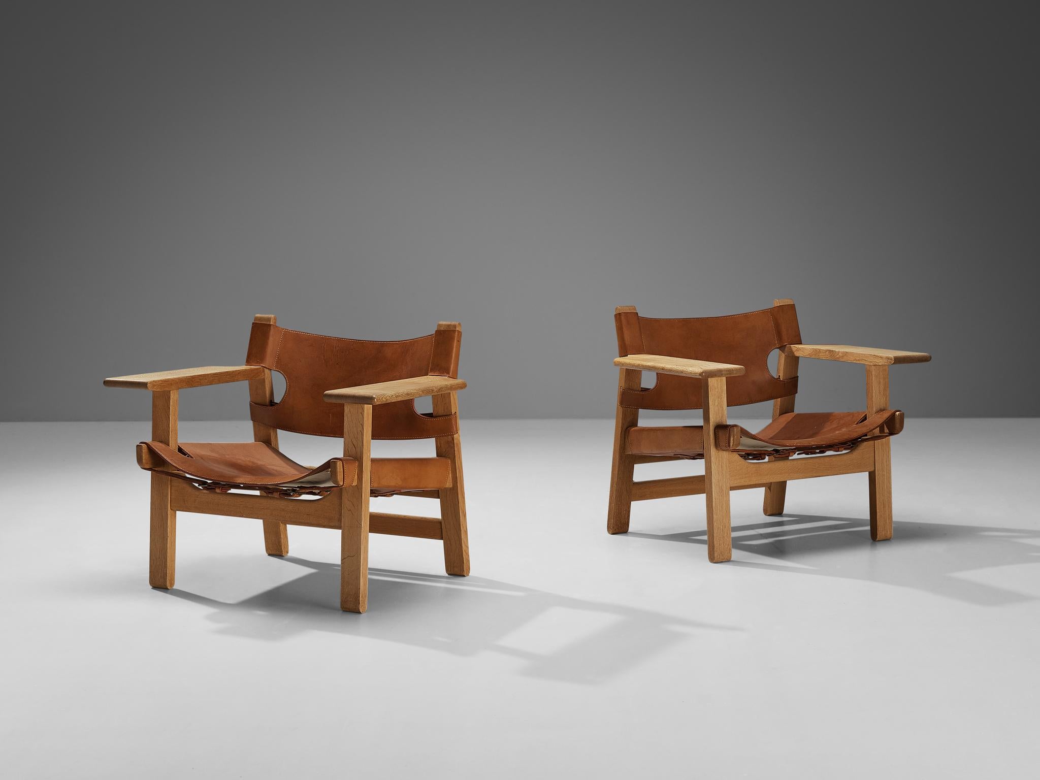 Børge Mogensen for Fredericia Stolefabrik, pair of 'Spanish Chairs,' oak, leather, brass, Denmark, design 1958

This well-known design by Børge Mogensen has a very strong appearance. The sincere construction and type of upholstery, give the chair a