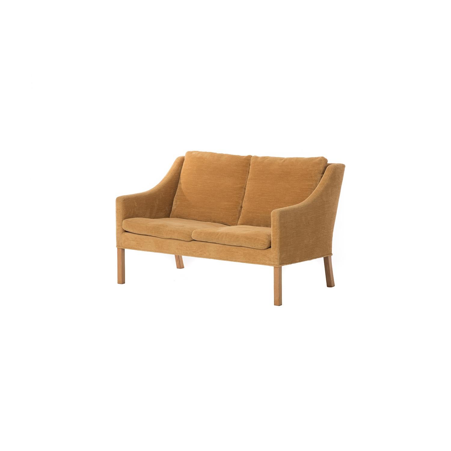 This classic Børge Mogensen settee with oak legs is upholstered in a butternut colored chenille. Down cushions.