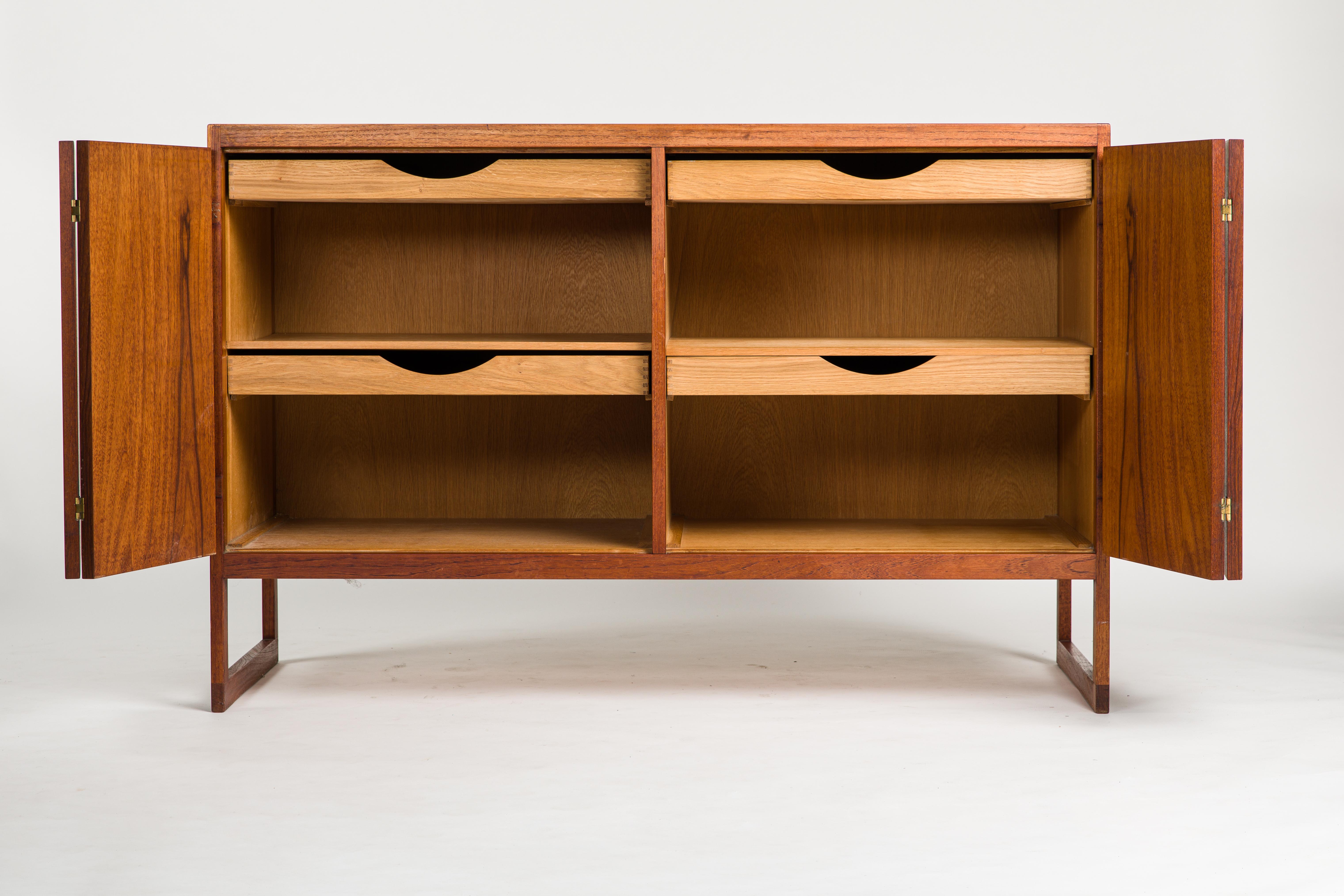 Update: the sideboard was oiled up professional after the photo shooting and looks now even better, a beautiful dark and shiny brown surface (check last picture).

Teak sideboard model 