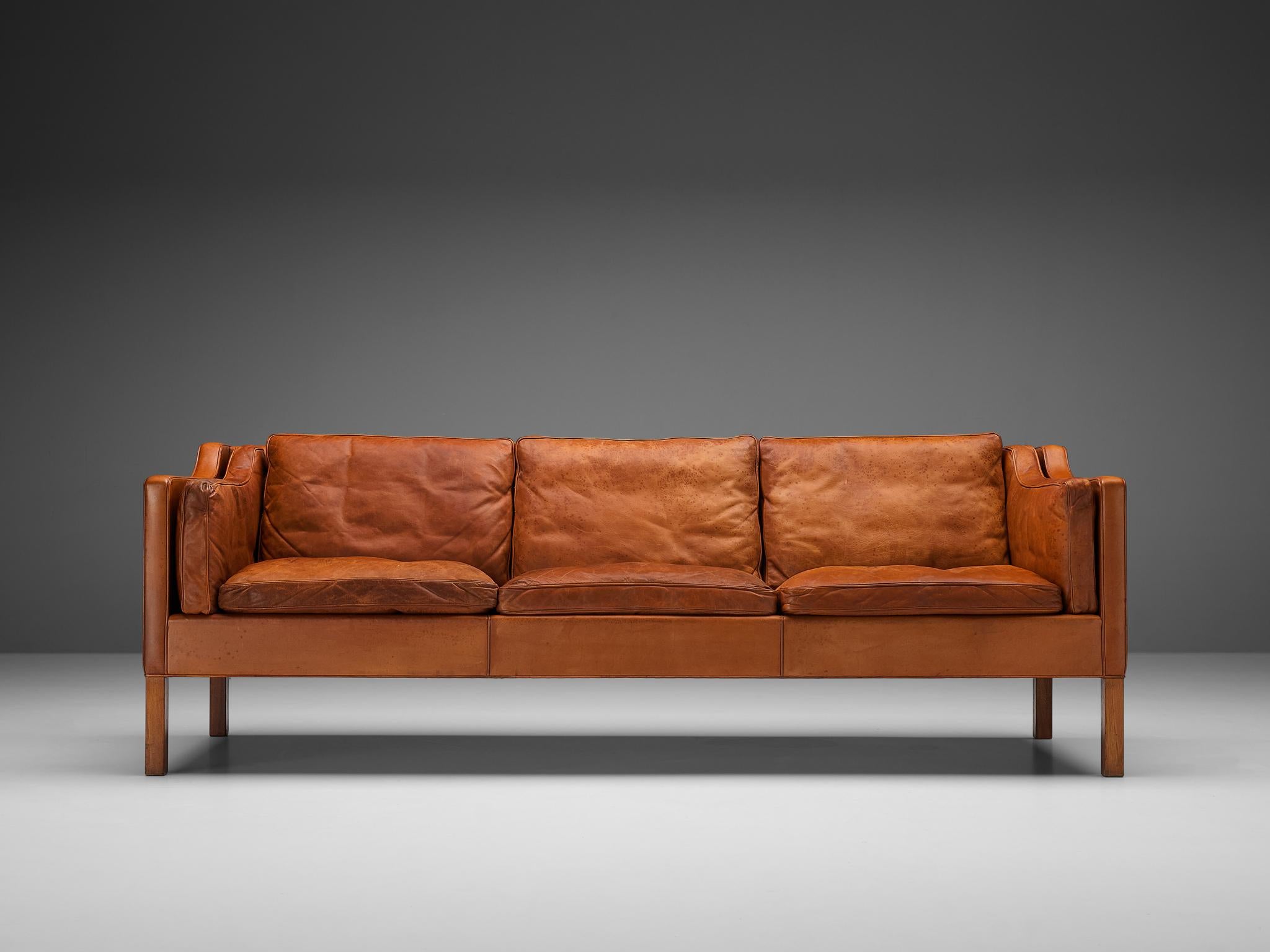 Børge Mogensen for Fredericia Stolefabrik, three-seat sofa model BM2213, leather and stained oak, Denmark, 1962

Very well balanced design by Børge Mogensen. The model 2213 was designed by Mogensen for his own home. The cognac leather shows