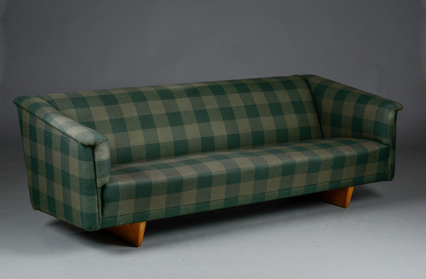 An Early Børge Mogensen (1914-1972) sofa, model 4853, upholstered in wool fabric, solid oak legs. Designed in 1953. Produced by Tage Kristensen L. 210 cm. Traces of wear.