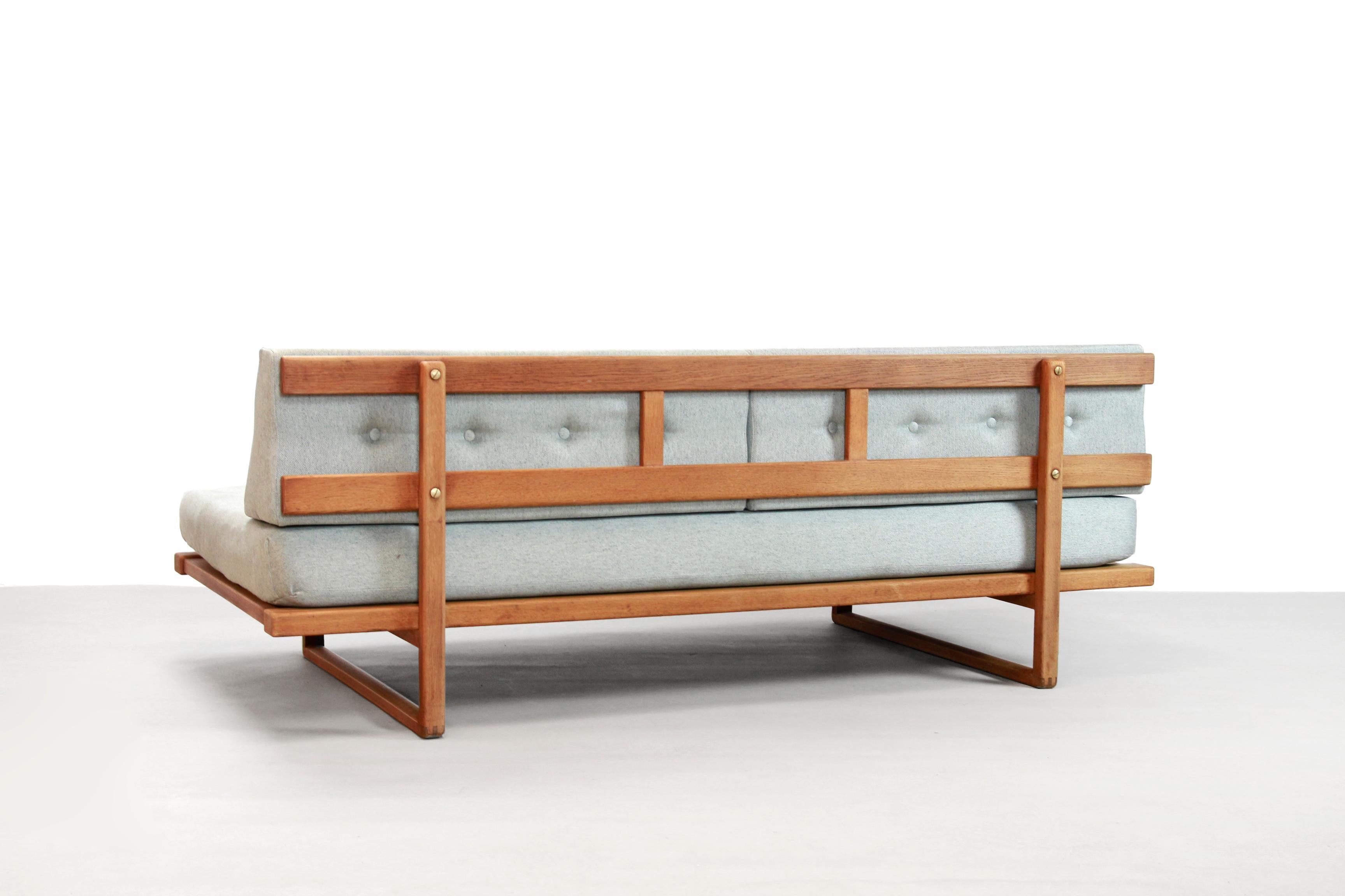 Solid oak wooden daybed designed in the late 1950s by Danish designer Børge Mogensen and produced by Fredericia Stolefabrik, Denmark. This sofa is named model 4312 or model 312 and is made of solid oakwood, brass details and deep buttoned cushions