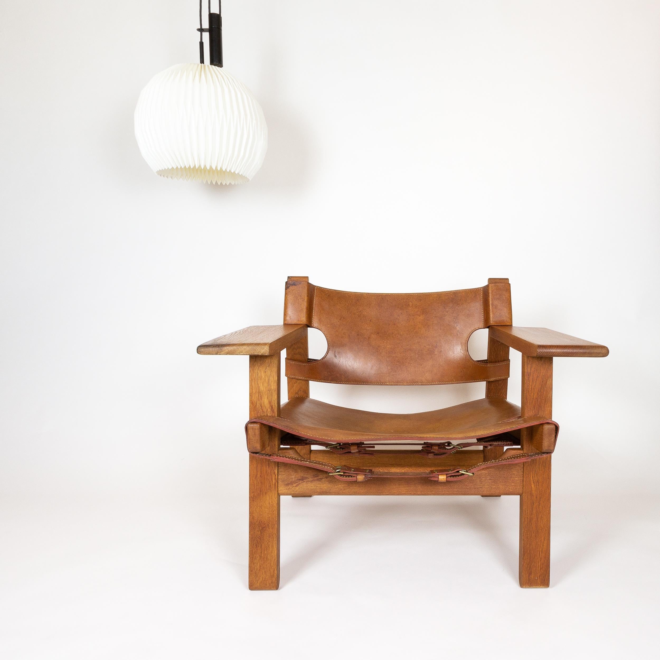 A fine example of Børge Mogensen's iconic Spanish chair on solid oak and cognac leather, designed in 1958. Excellent wear and patina. Fredericia, Denmark, 1960s. Sourced from Odense, Denmark, 35 miles from where it was made.