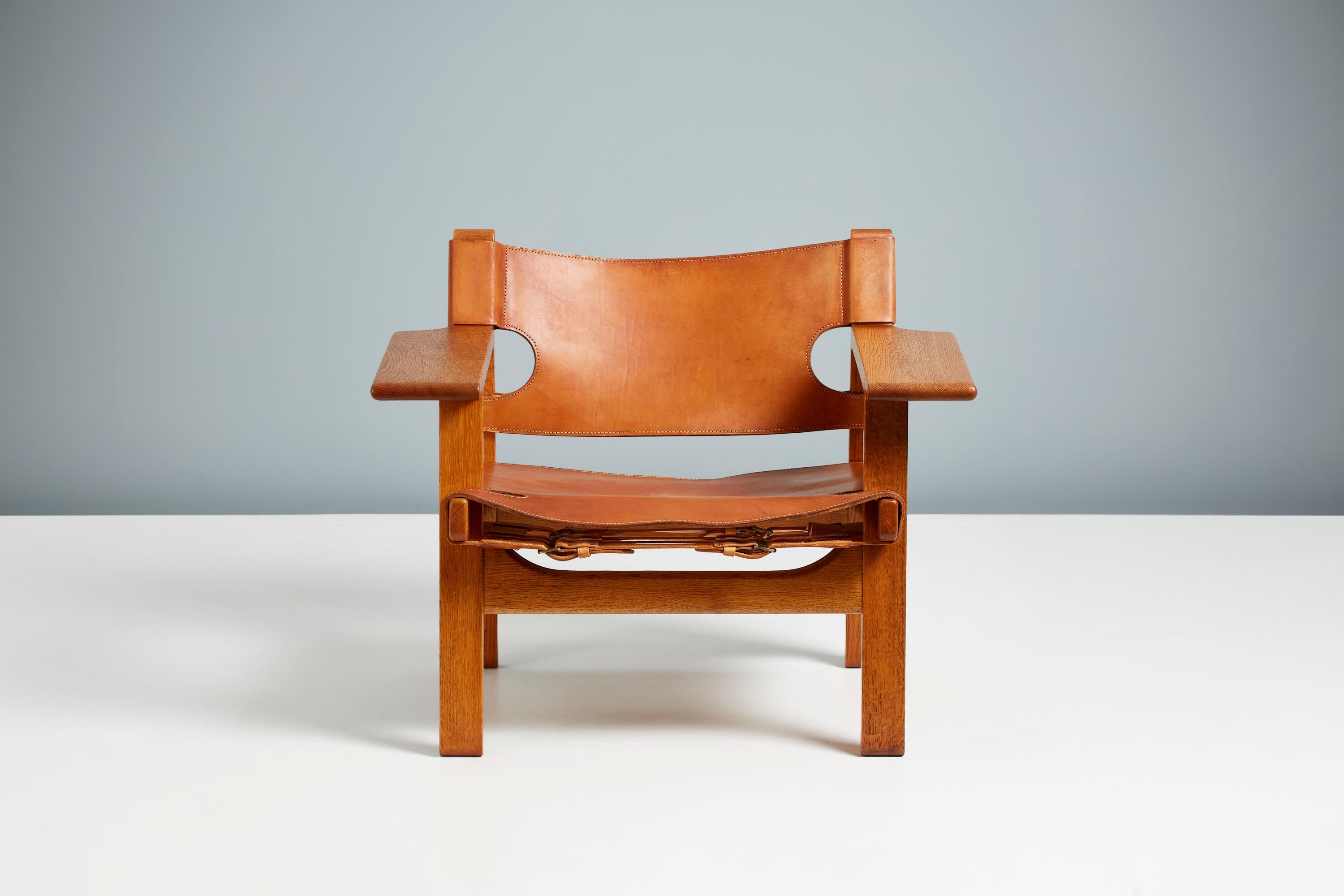 Børge Mogensen

The Spanish Chair, circa 1958

Manufactured by Fredericia Stolefabrik, Copenhagen, Denmark. Solid oak frame with original, patinated tan saddle leather seat and back and brass fittings. This example produced in the 1960s. Minor