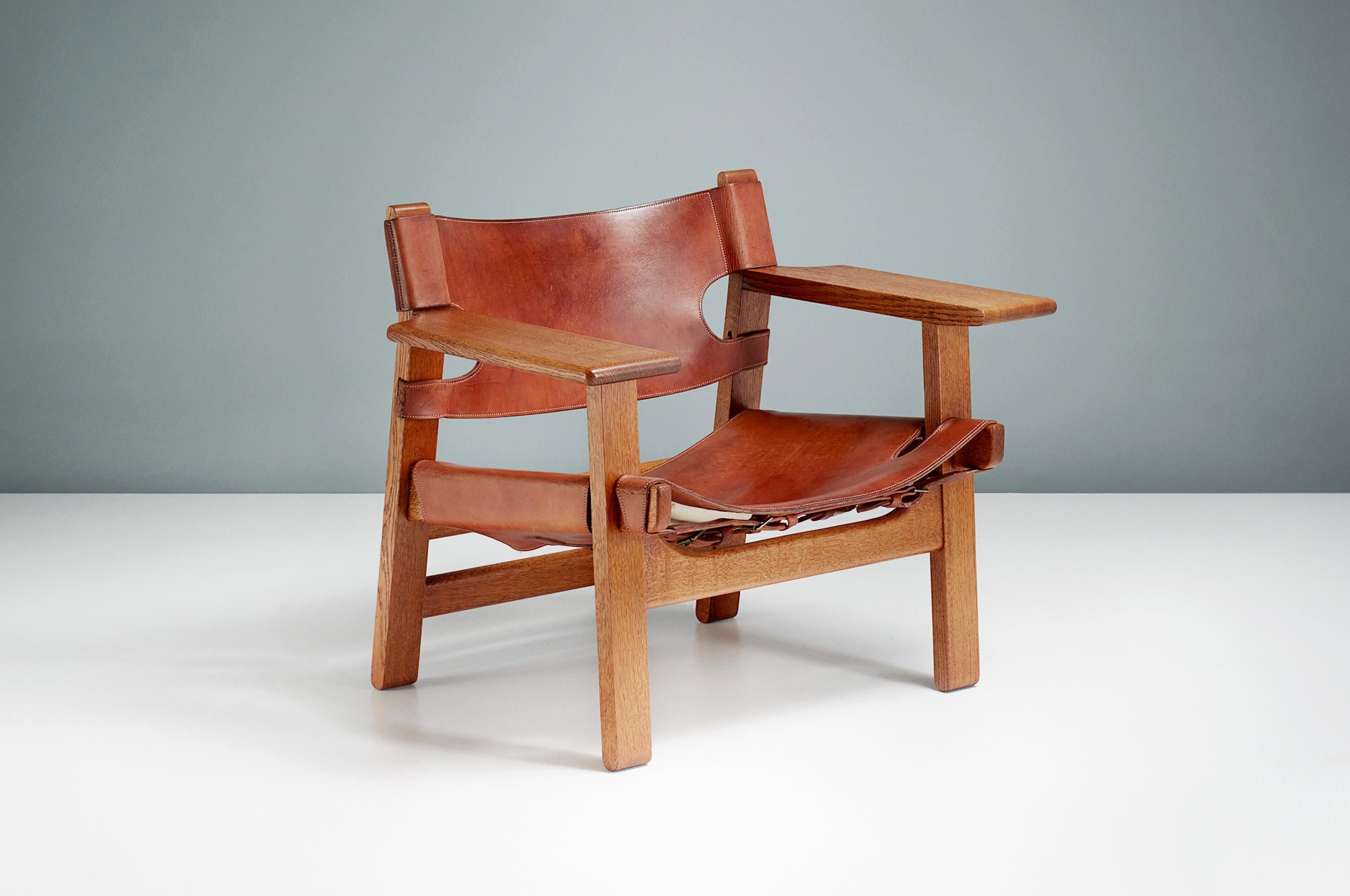Børge Mogensen

The Spanish Chair, c1958

Manufactured by Fredericia Stolefabrik, Copenhagen, Denmark. Solid oak frame with original, patinated tan saddle leather seat and back and brass fittings. This example was produced in the 1960s.

In 1958,